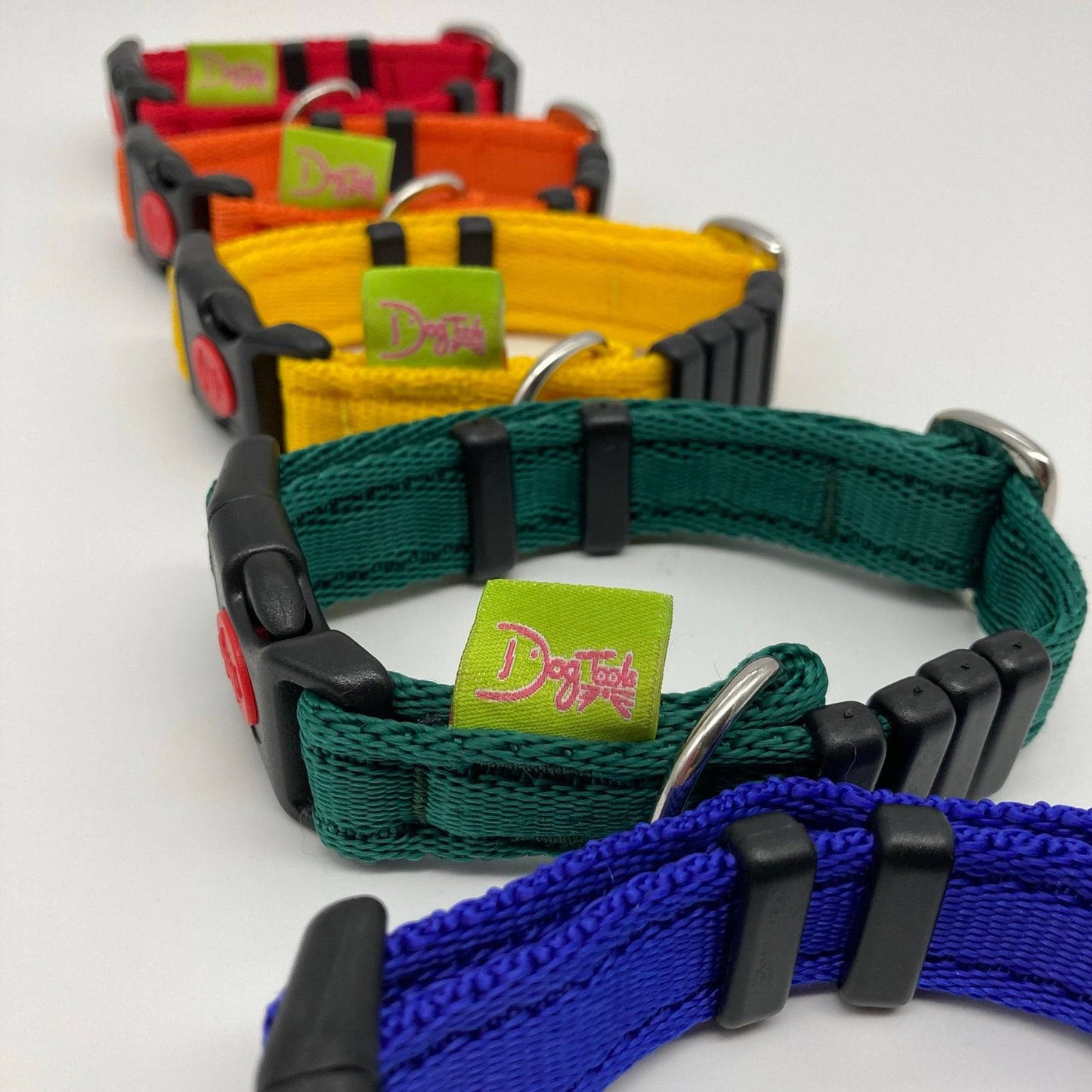 DogTools collars shown vertically in a row, with the applegreen DogTools label shown, collars in the colors red, orange, yellow, green, blue