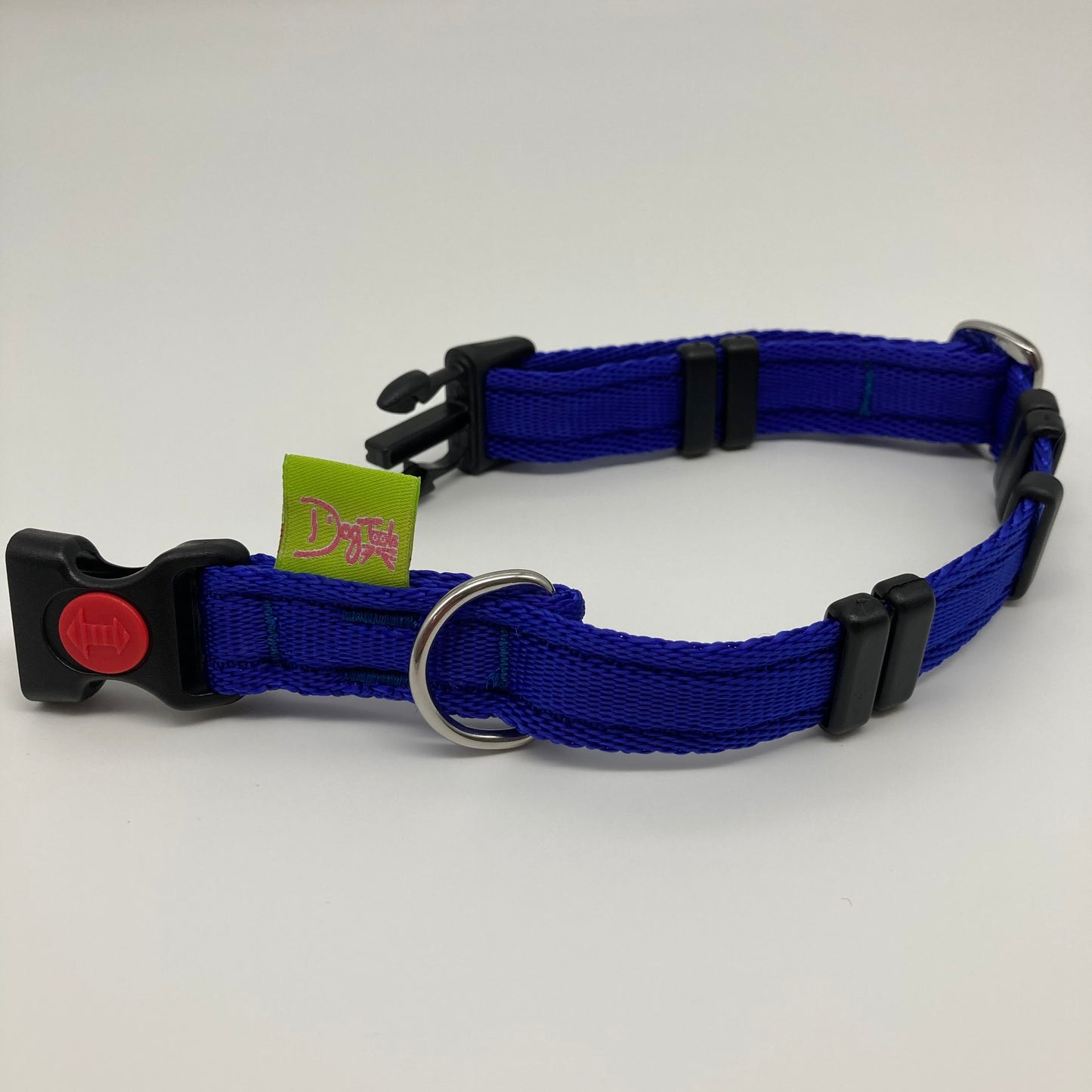 blue collar displayed on a white surface, unlocked, showing the black lock, stainless steel ring, the black loops and the applegreen DogTools label