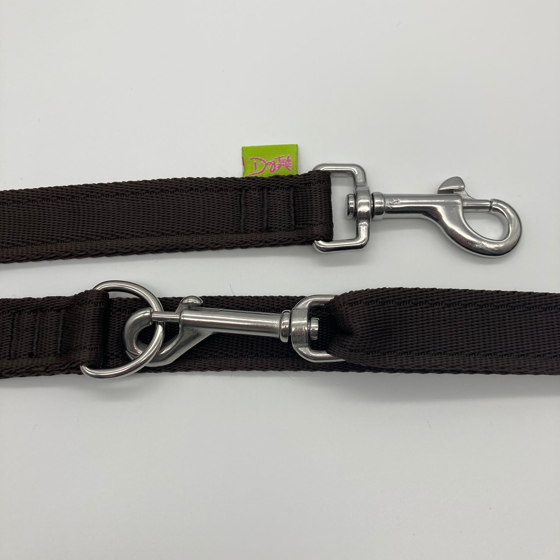 brown multifunctional leash in size large, showing the 2 stainless steel hooks and the applegreen label with DogTools logo on it