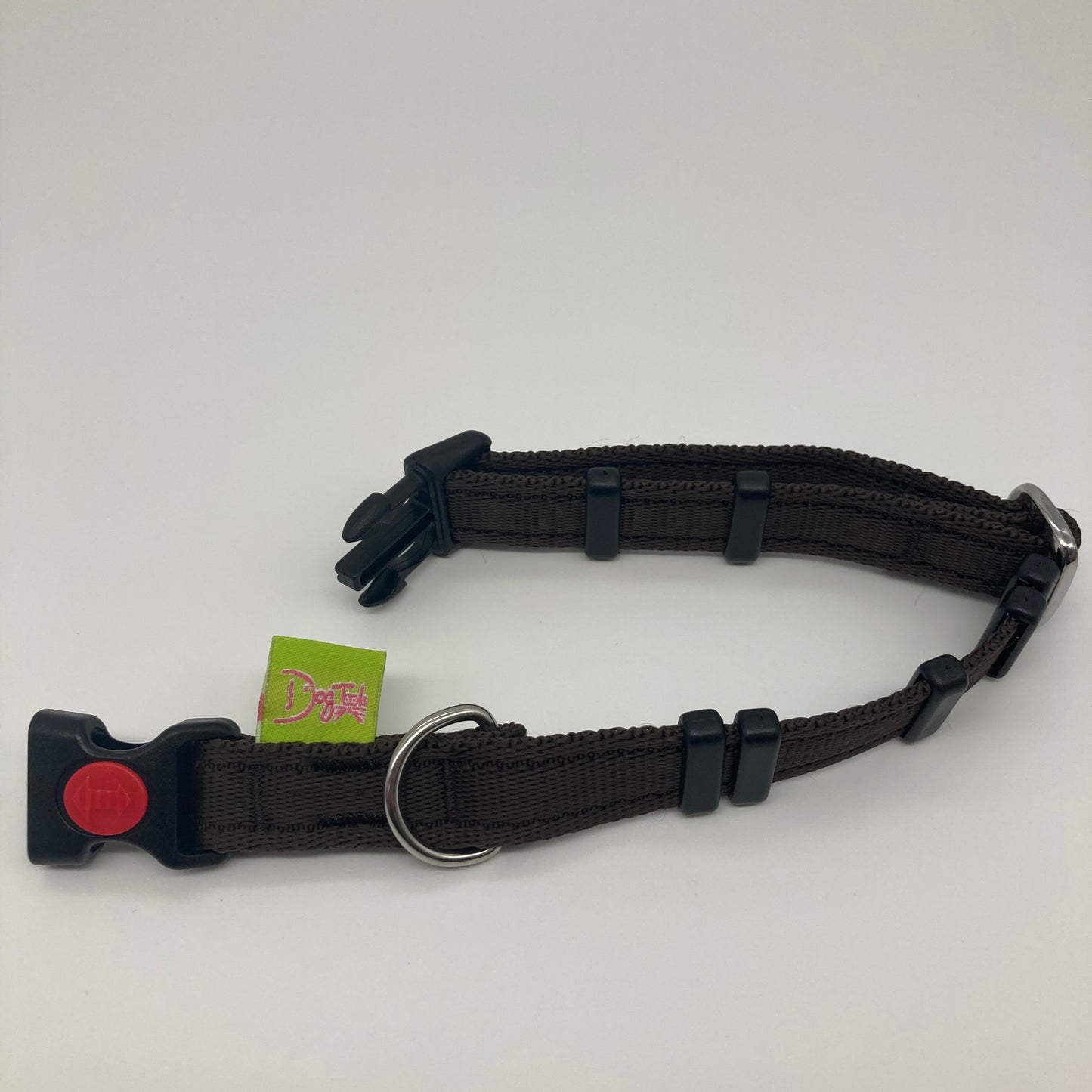 brown collar displayed on a white surface, unlocked, showing the black lock, stainless steel ring, the black loops and the applegreen DogTools label