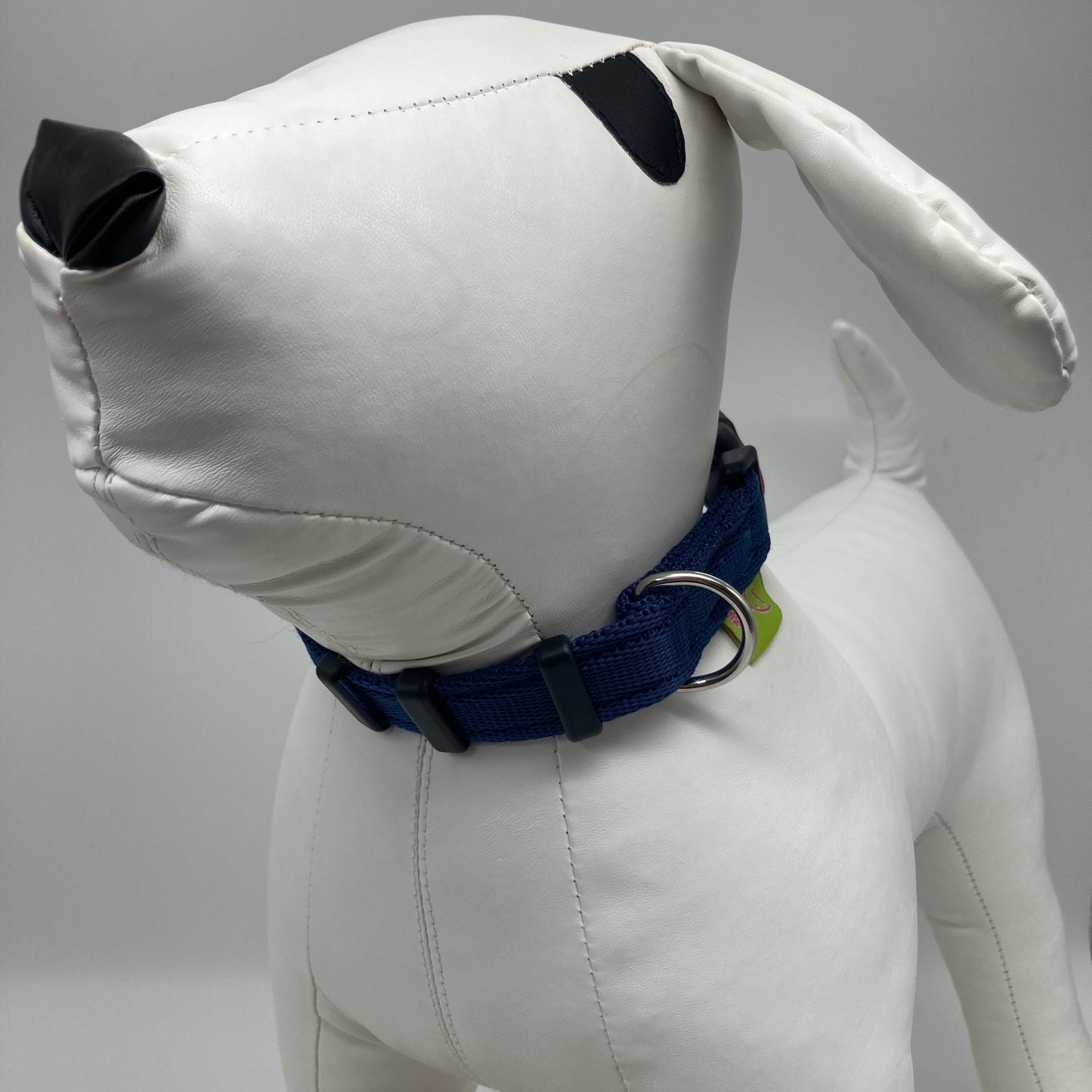 dark blue collar displayed on a stuffed toy (dog), from the front of the dog, showing its head and torso