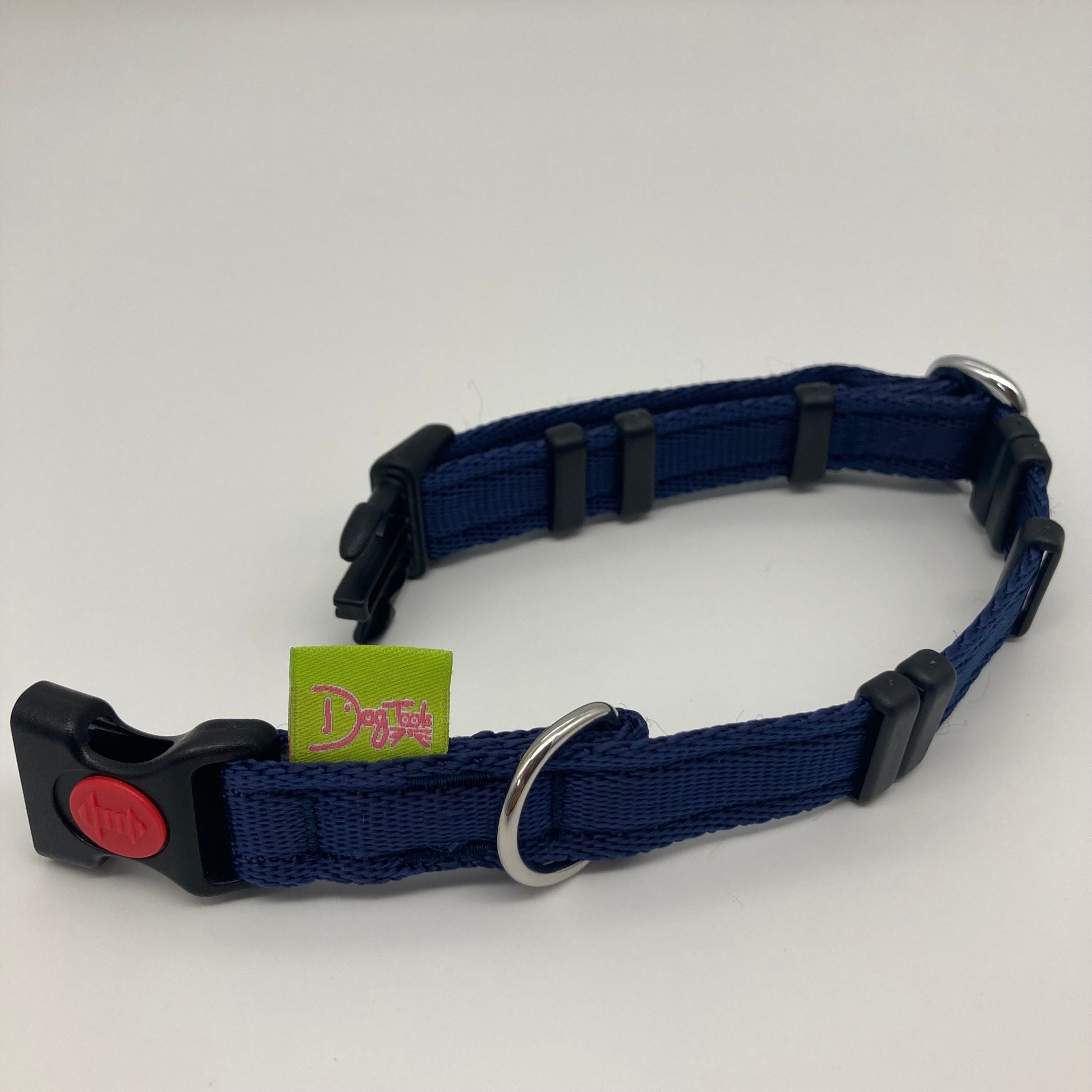 dark blue collar displayed on a white surface, unlocked, showing the black lock, stainless steel ring, the black loops and the applegreen DogTools label