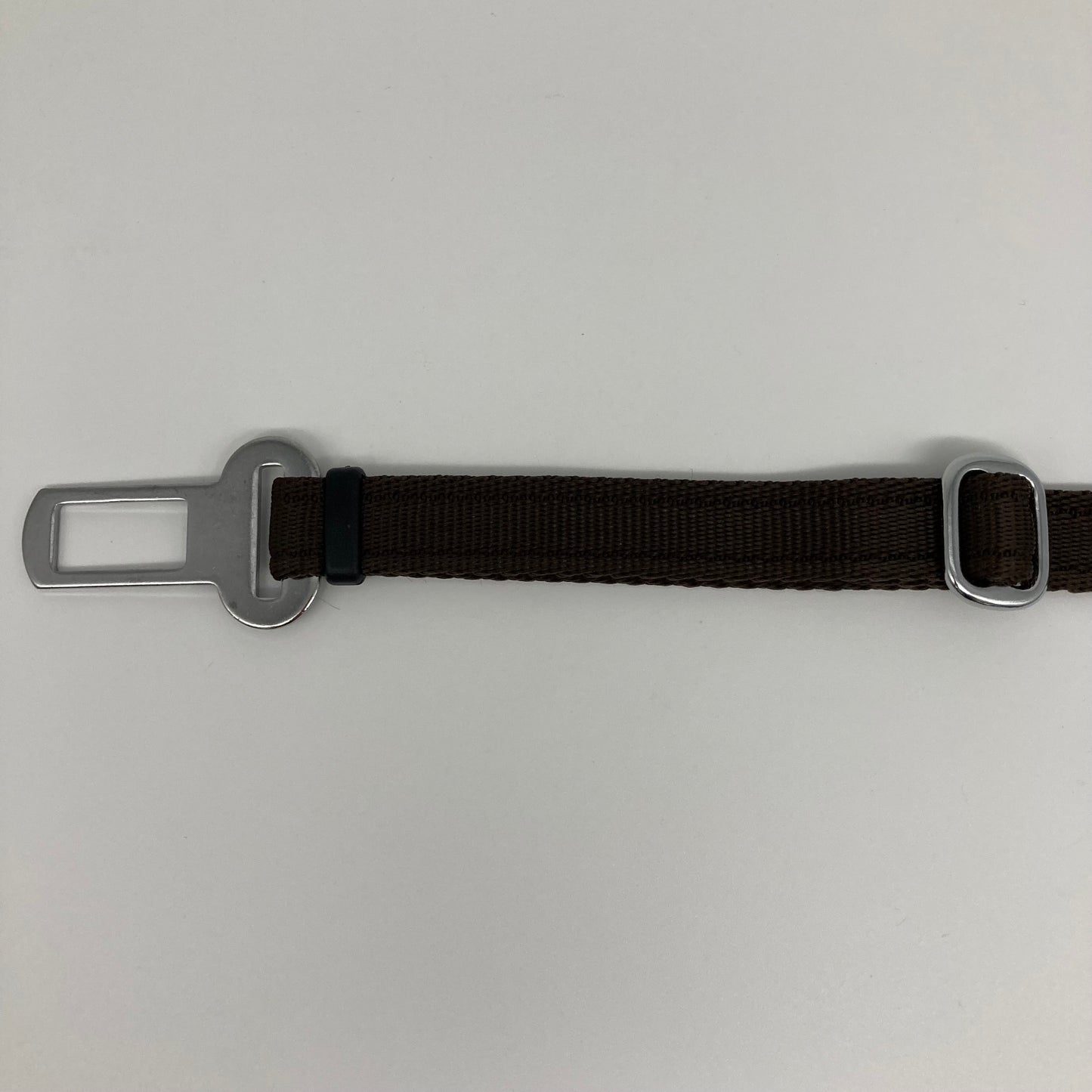brown car safety belt, showing the stainless steel buckle and the stainless steel clasp to adjust the length of the belt