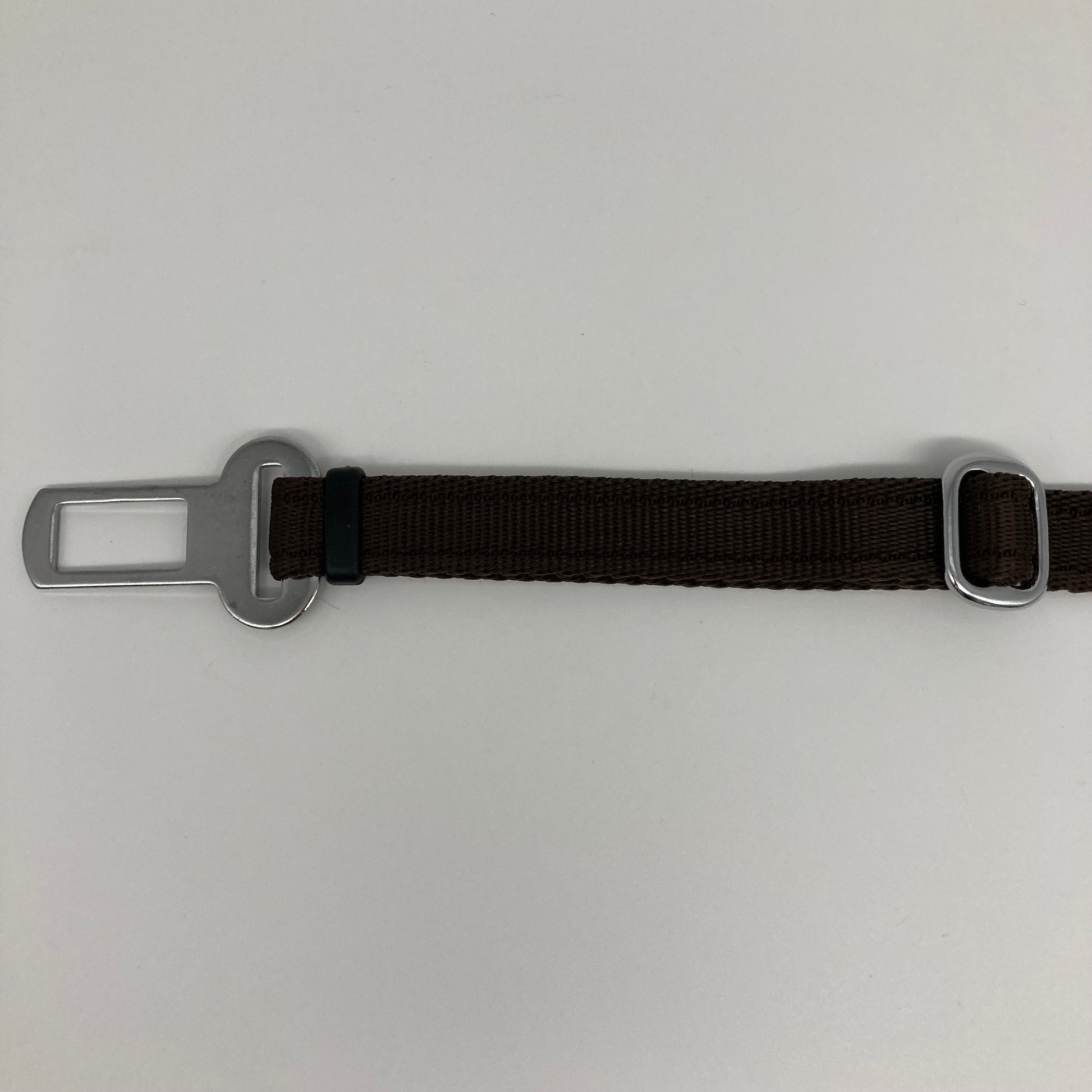 brown car safety belt, showing the stainless steel buckle and the stainless steel clasp to adjust the length of the belt
