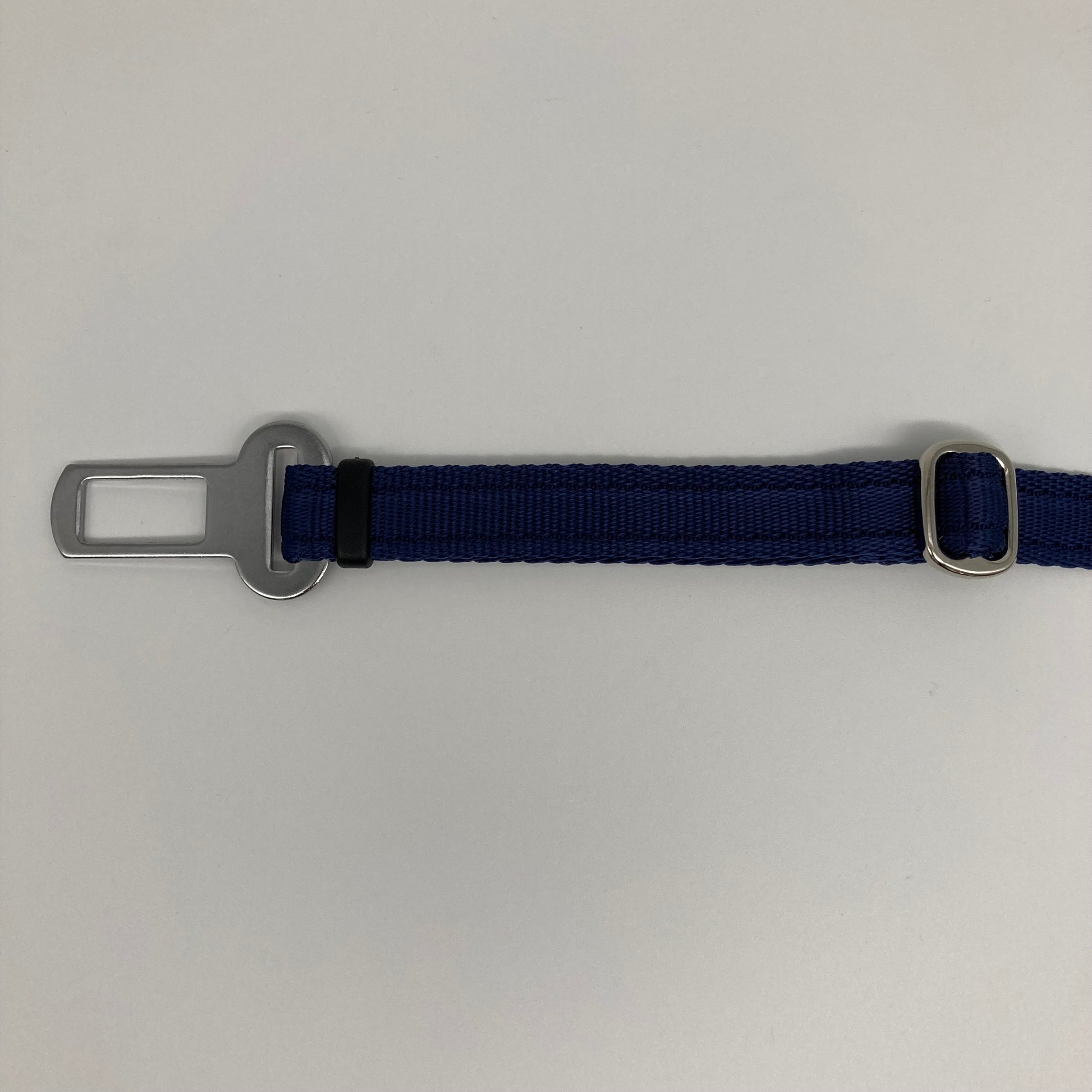 dark blue car safety belt, showing the stainless steel buckle and the stainless steel clasp to adjust the length of the belt