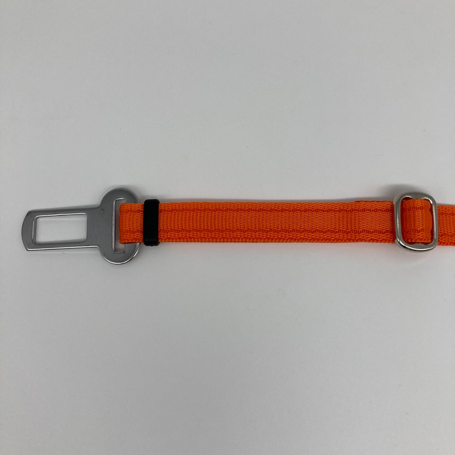 orange car safety belt, showing the stainless steel buckle and the stainless steel clasp to adjust the length of the belt