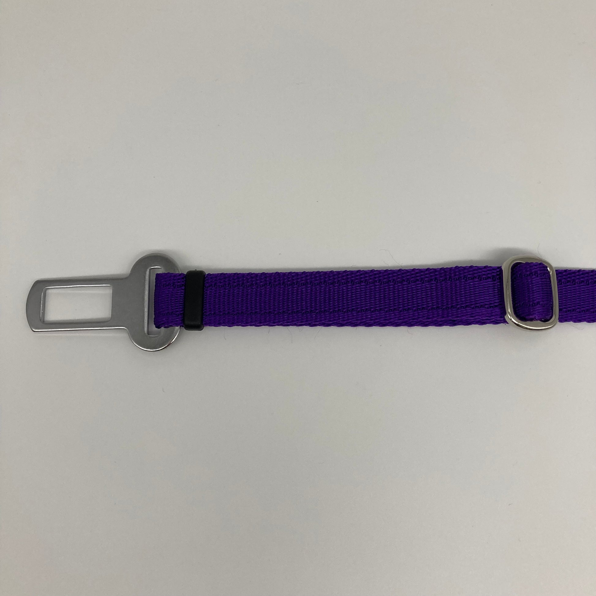 purple car safety belt, showing the stainless steel buckle and the stainless steel clasp to adjust the length of the belt