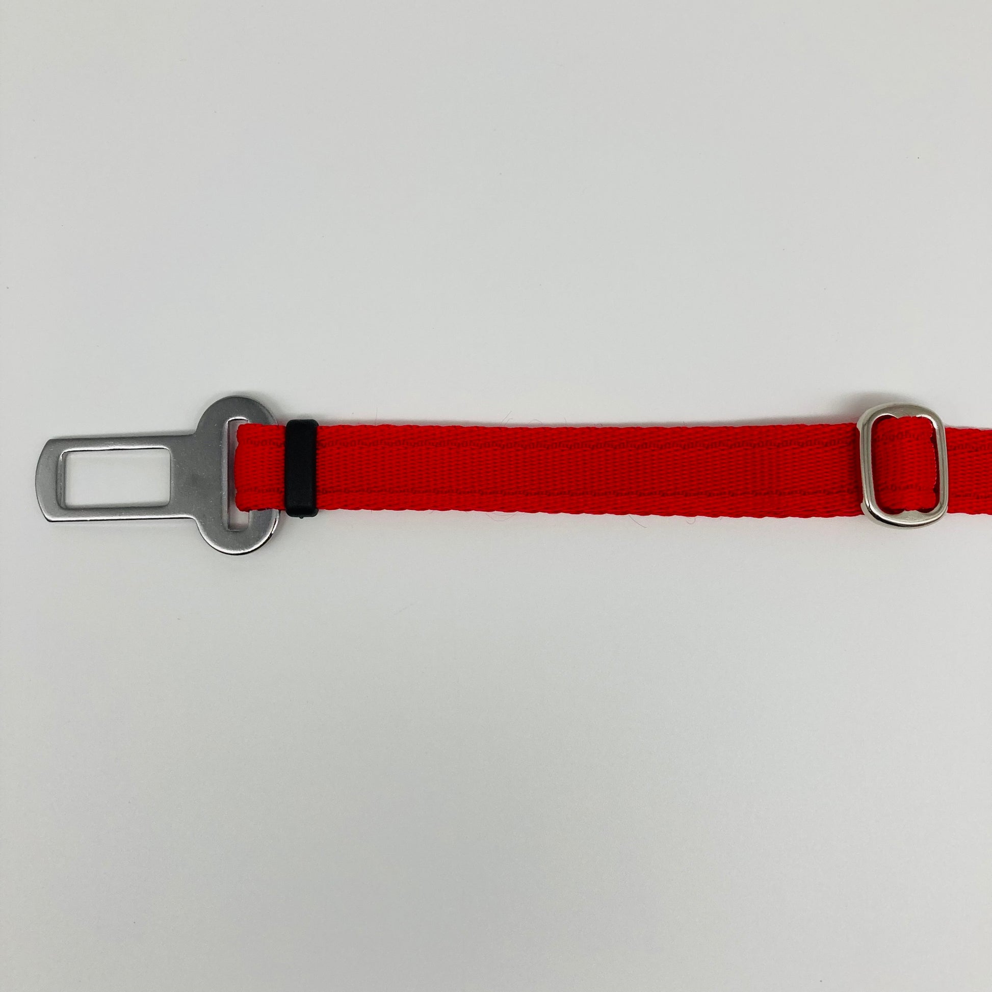 red car safety belt, showing the stainless steel buckle and the stainless steel clasp to adjust the length of the belt