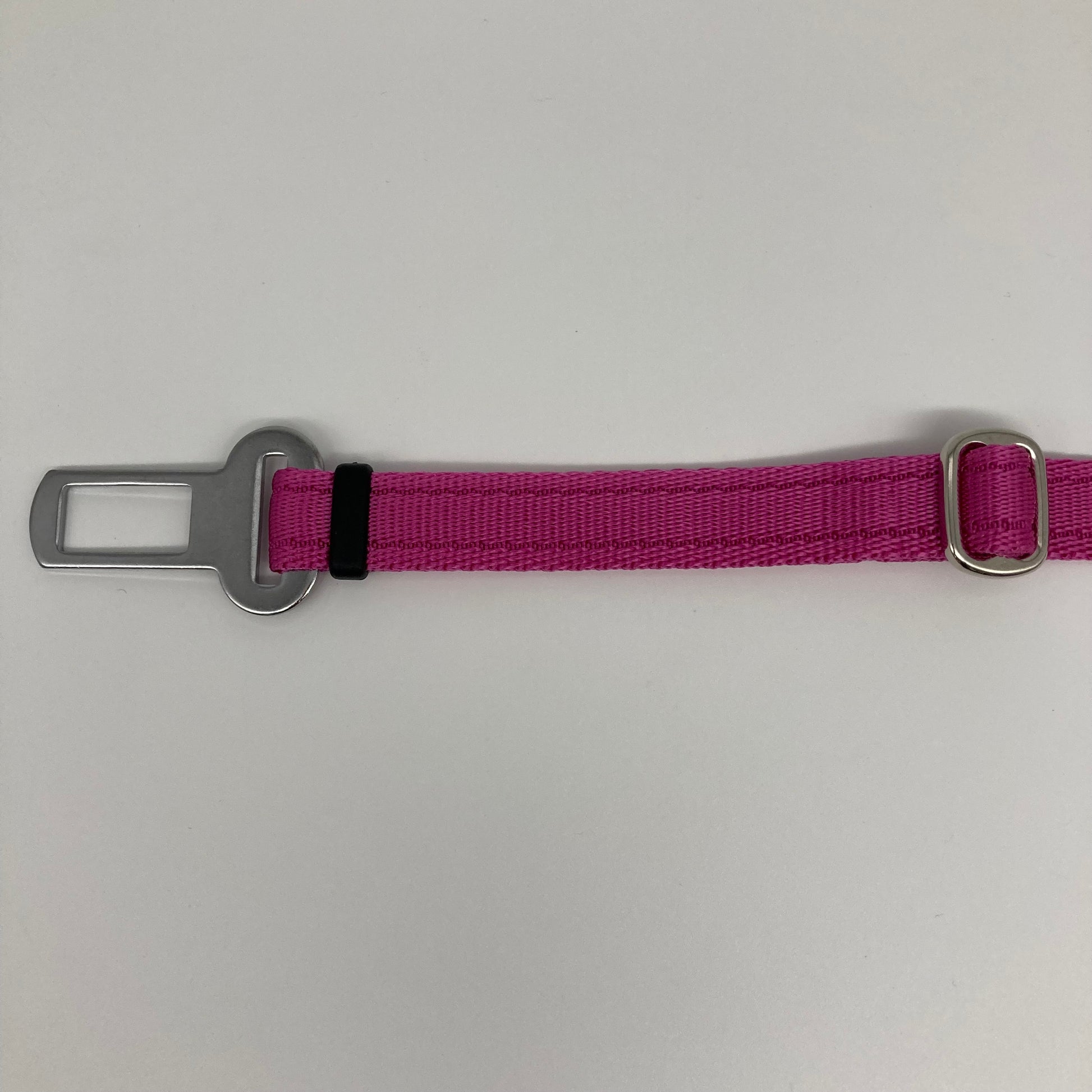 pink car safety belt, showing the stainless steel buckle and the stainless steel clasp to adjust the length of the belt