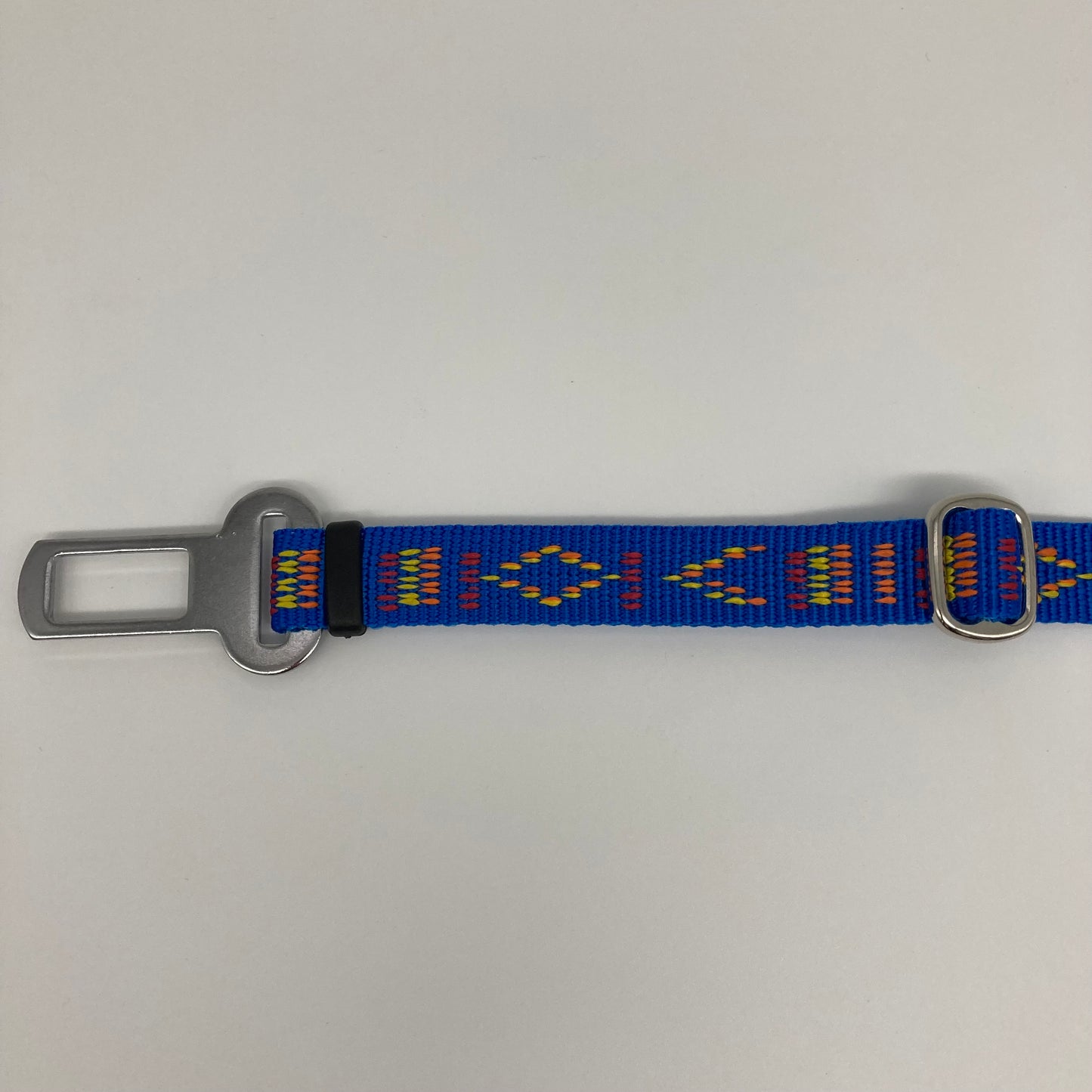 blue Stitch (blue fabric with print in 3 colors, red, yellow and orange)  car safety belt, showing the stainless steel buckle and the stainless steel clasp to adjust the length of the belt