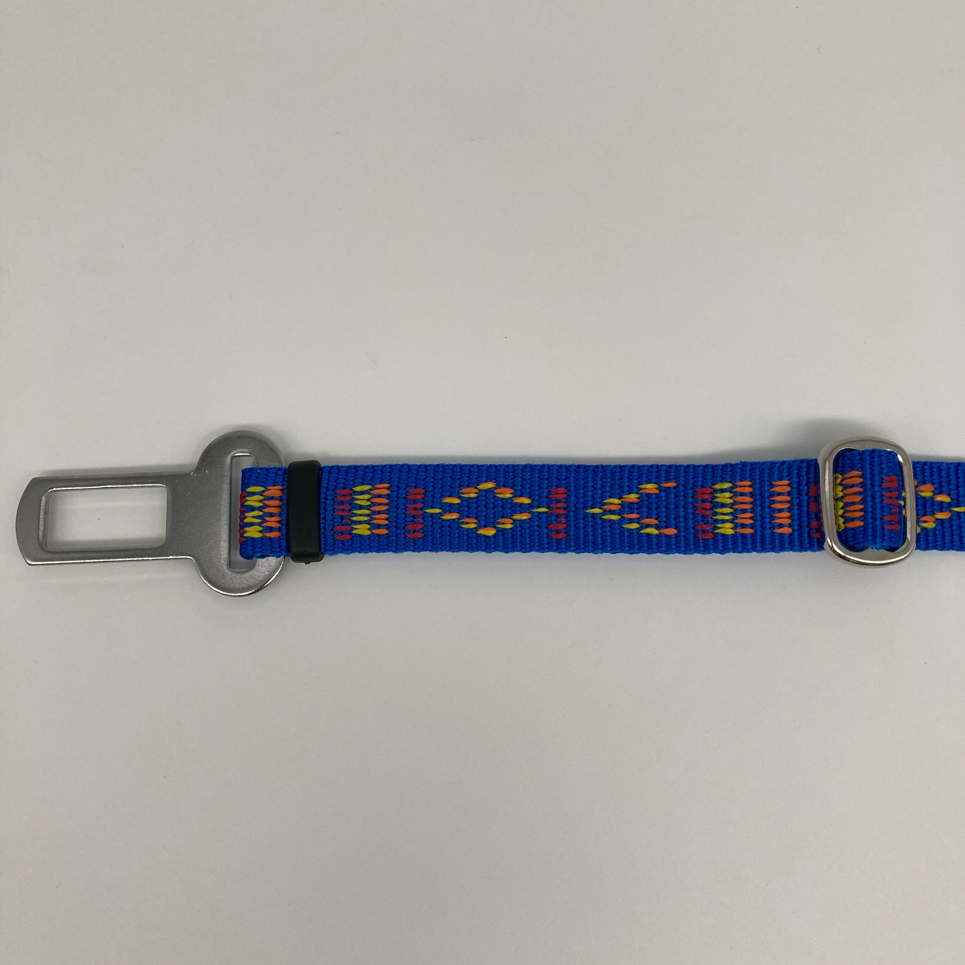 blue Stitch (blue fabric with print in 3 colors, red, yellow and orange)  car safety belt, showing the stainless steel buckle and the stainless steel clasp to adjust the length of the belt