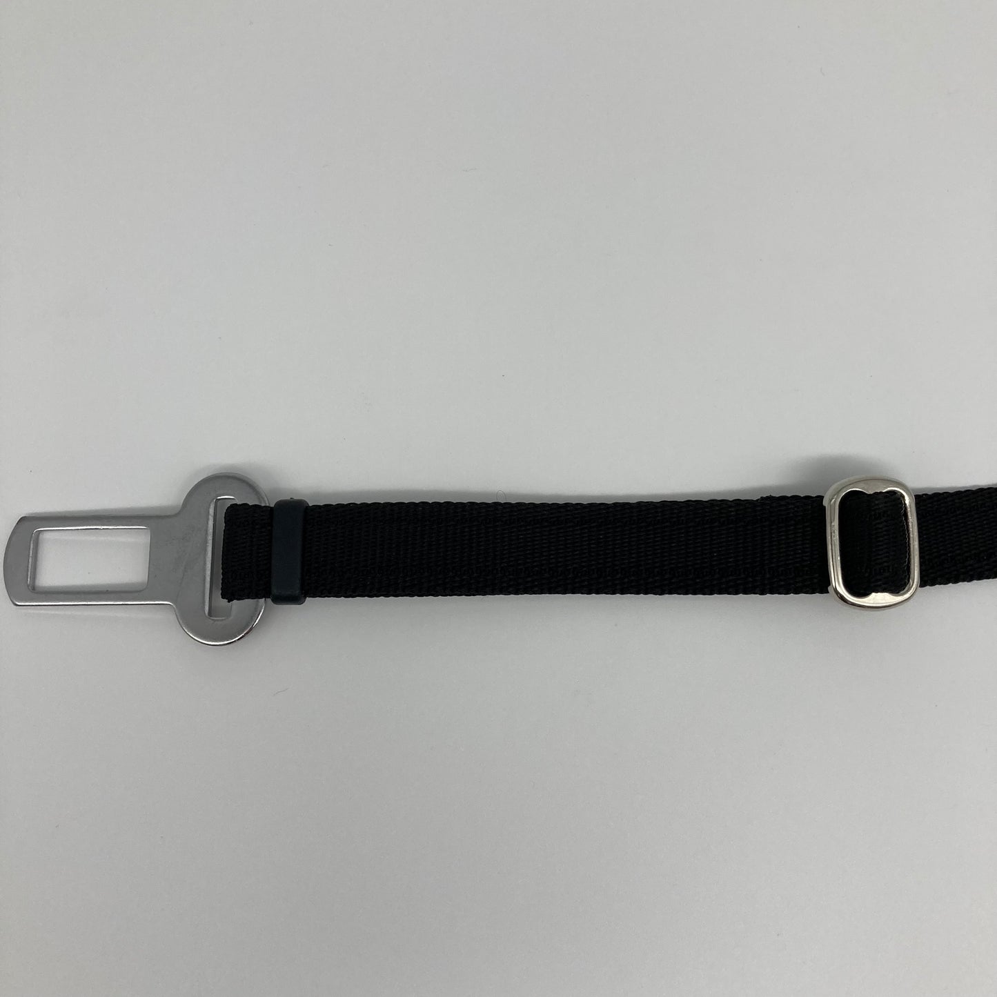 black car safety belt, showing the stainless steel buckle and the stainless steel clasp to adjust the length of the belt