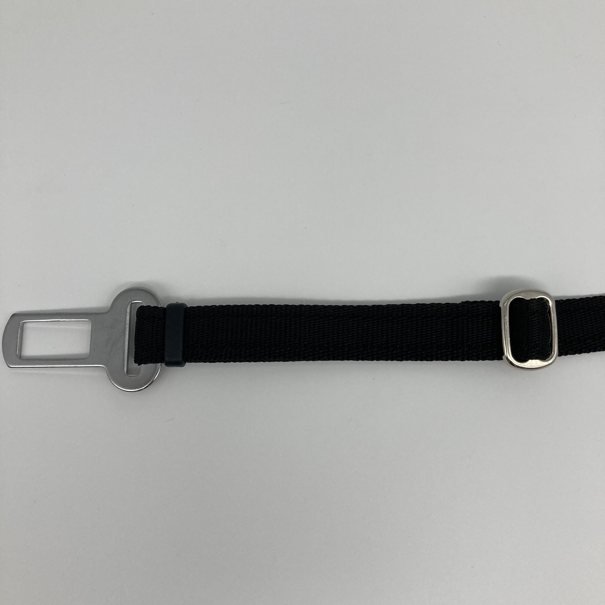 black car safety belt, showing the stainless steel buckle and the stainless steel clasp to adjust the length of the belt