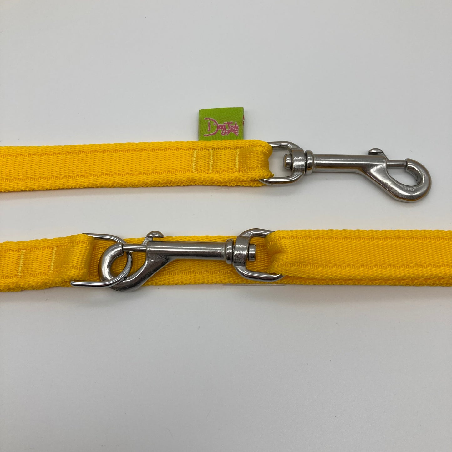 yellow multifunctional leash in size small, showing the 2 stainless steel hooks and the applegreen label with DogTools logo on it