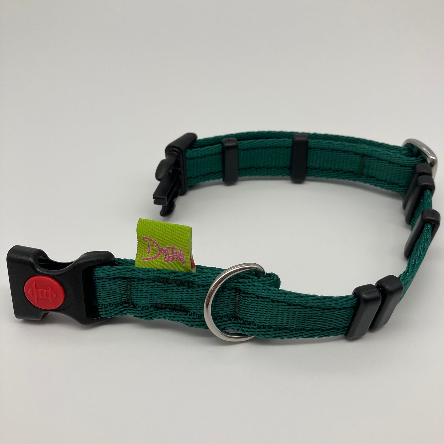 green collar displayed on a white surface, unlocked, showing the black lock, stainless steel ring, the black loops and the applegreen DogTools label