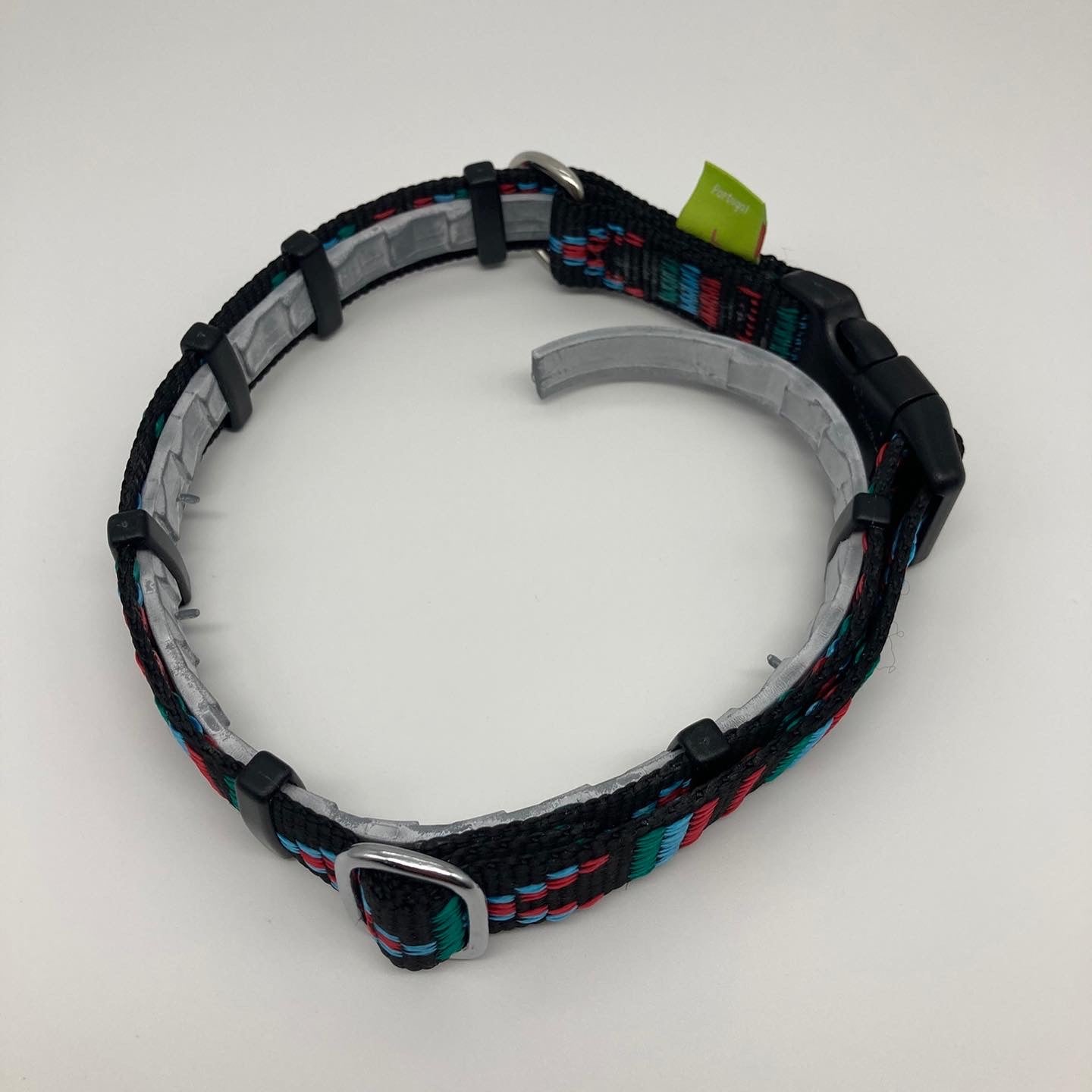 DogTools collar shown with a flea collar placed inside, color Stitch black (black fabric with print in 3 colors, red, light blue and green)