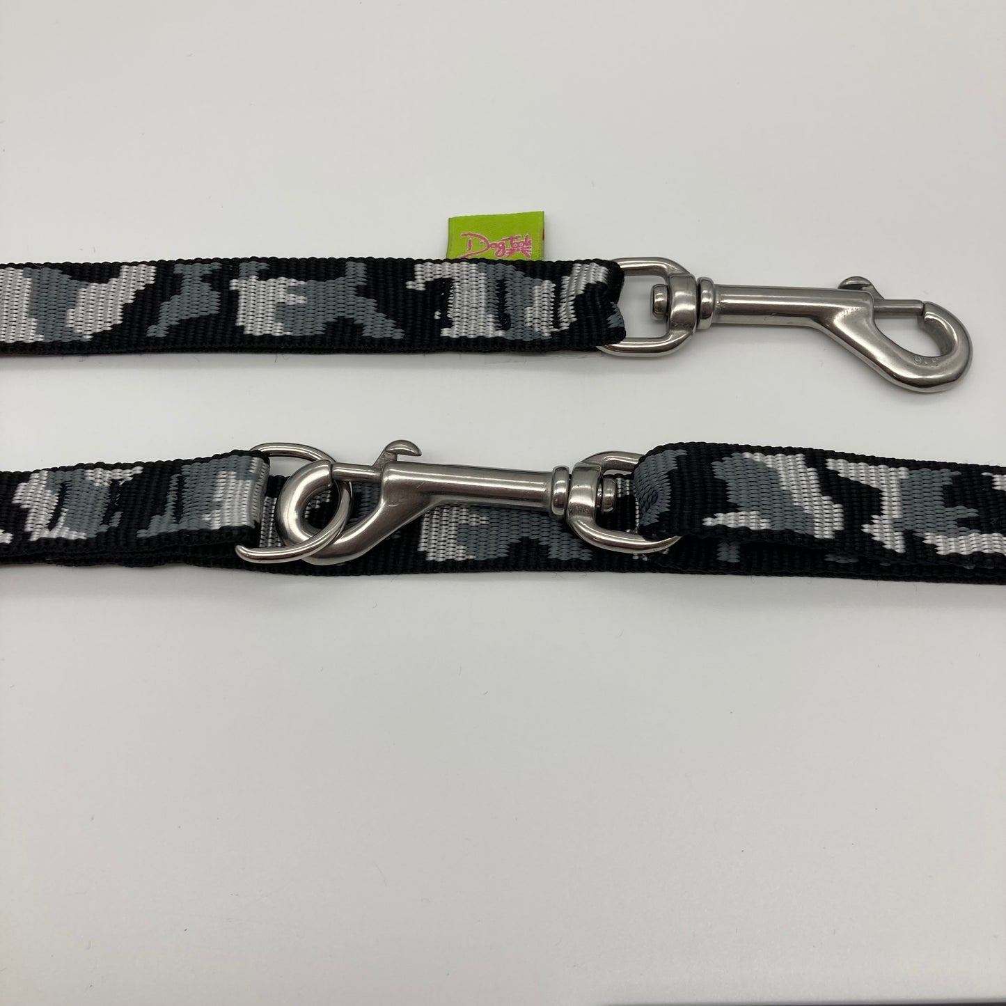 army grey (army print in 3 colors, dark grey, light grey and black) multifunctional leash in size small, showing the 2 stainless steel hooks and the applegreen label with DogTools logo on it
