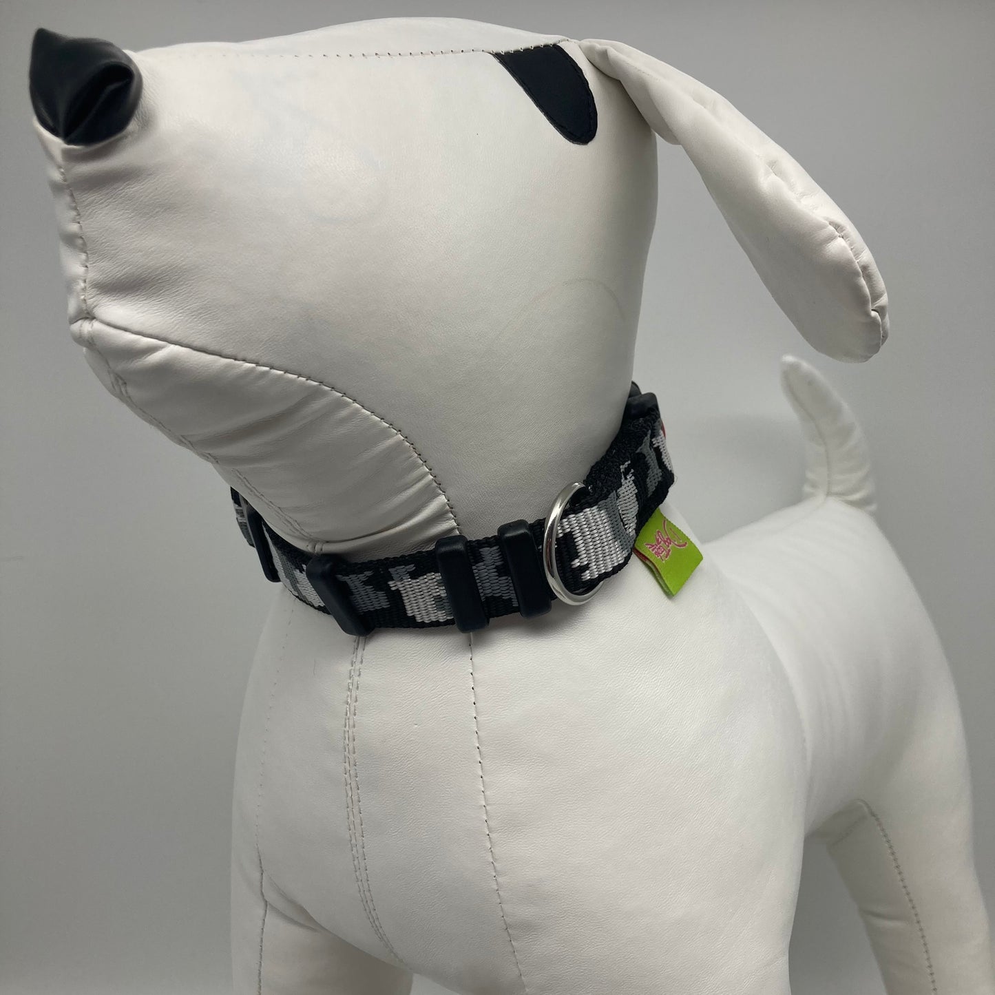 army grey (army print in 3 colors, dark grey, light grey and black) collar displayed on a stuffed toy (dog), from the front of the dog, showing its head and torso