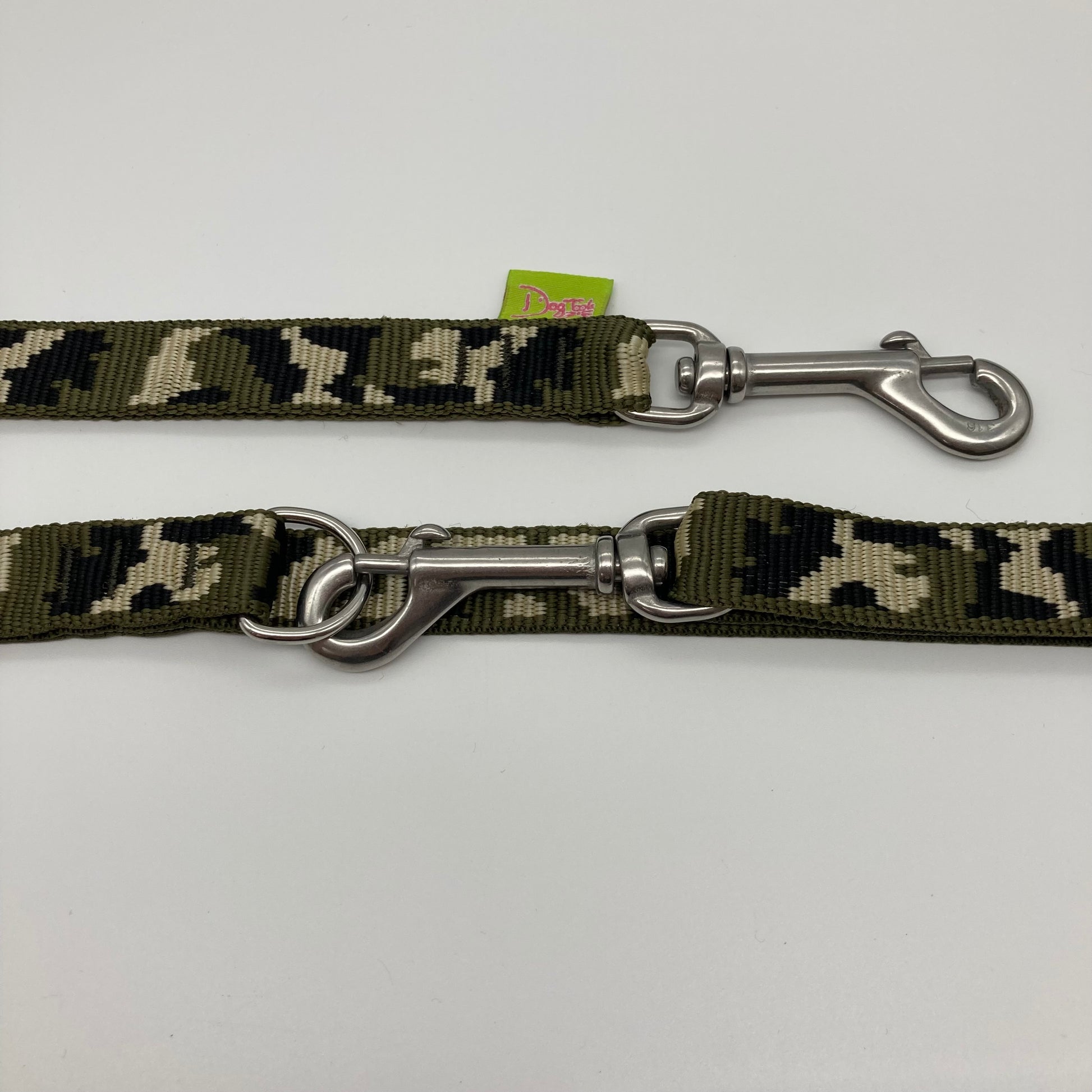 army green (army print in 3 colors, olive green, beige and black) multifunctional leash in size small, showing the 2 stainless steel hooks and the applegreen label with DogTools logo on it