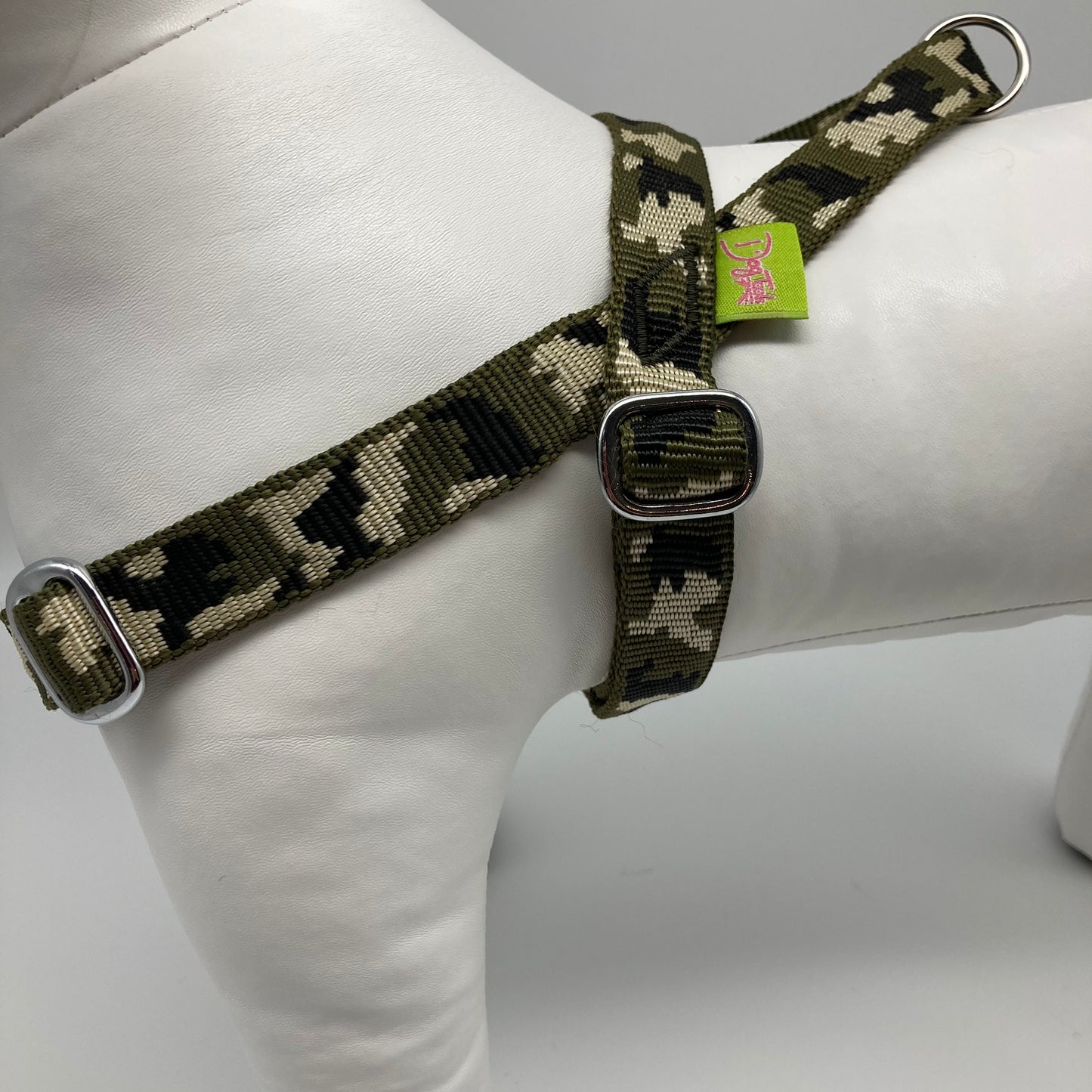 army green (army print in 3 colors, olive green, beige and black) harness, from the side, showing the loop, the stainless steel parts and the applegreen label