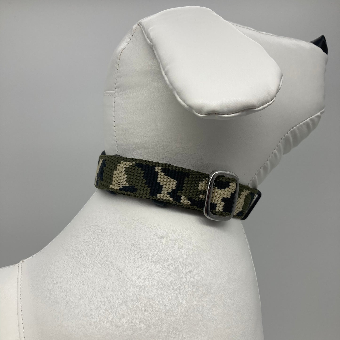 army green (army print in 3 colors, olive green, beige and black) collar displayed on a stuffed toy (dog), showing the back of the head and the collar from behind