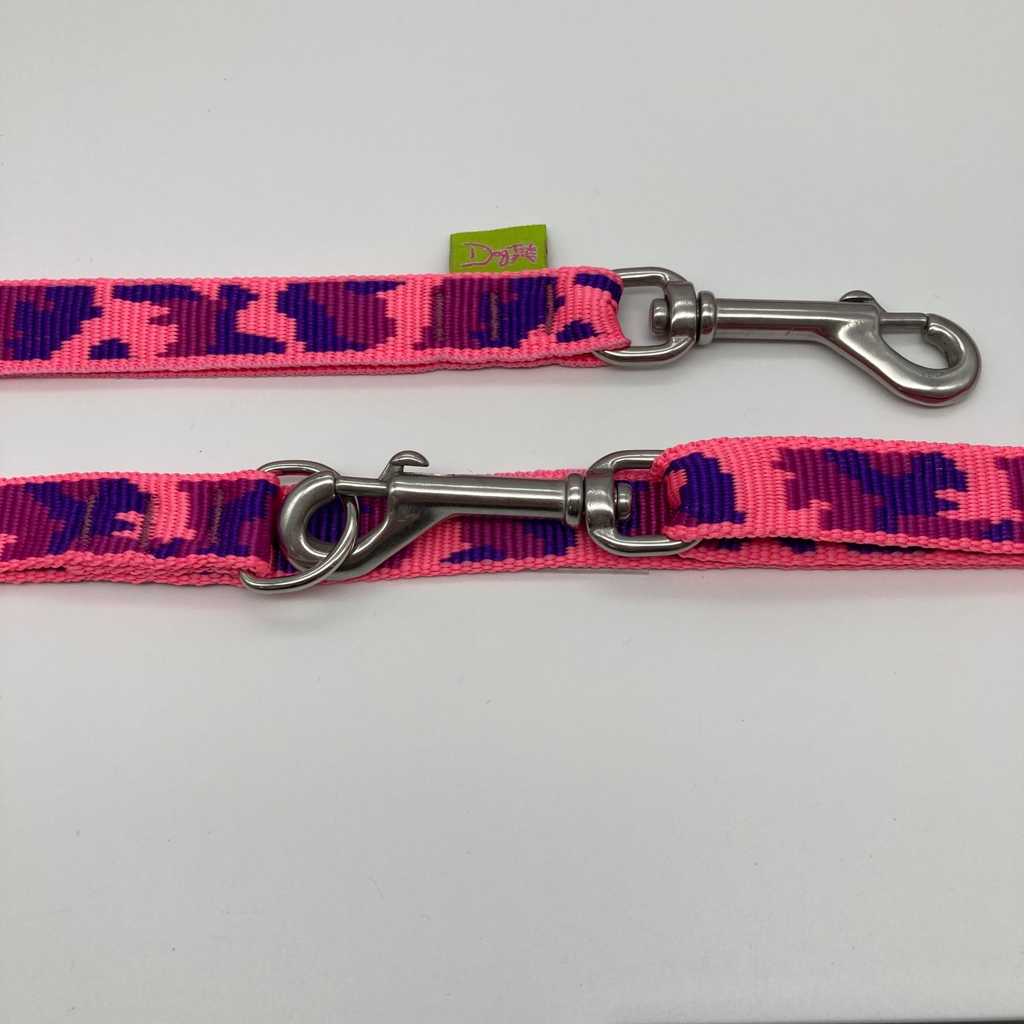 army pink (army print in 3 colors, fushia, purple and pink) multifunctional leash in size small, showing the 2 stainless steel hooks and the applegreen label with DogTools logo on it