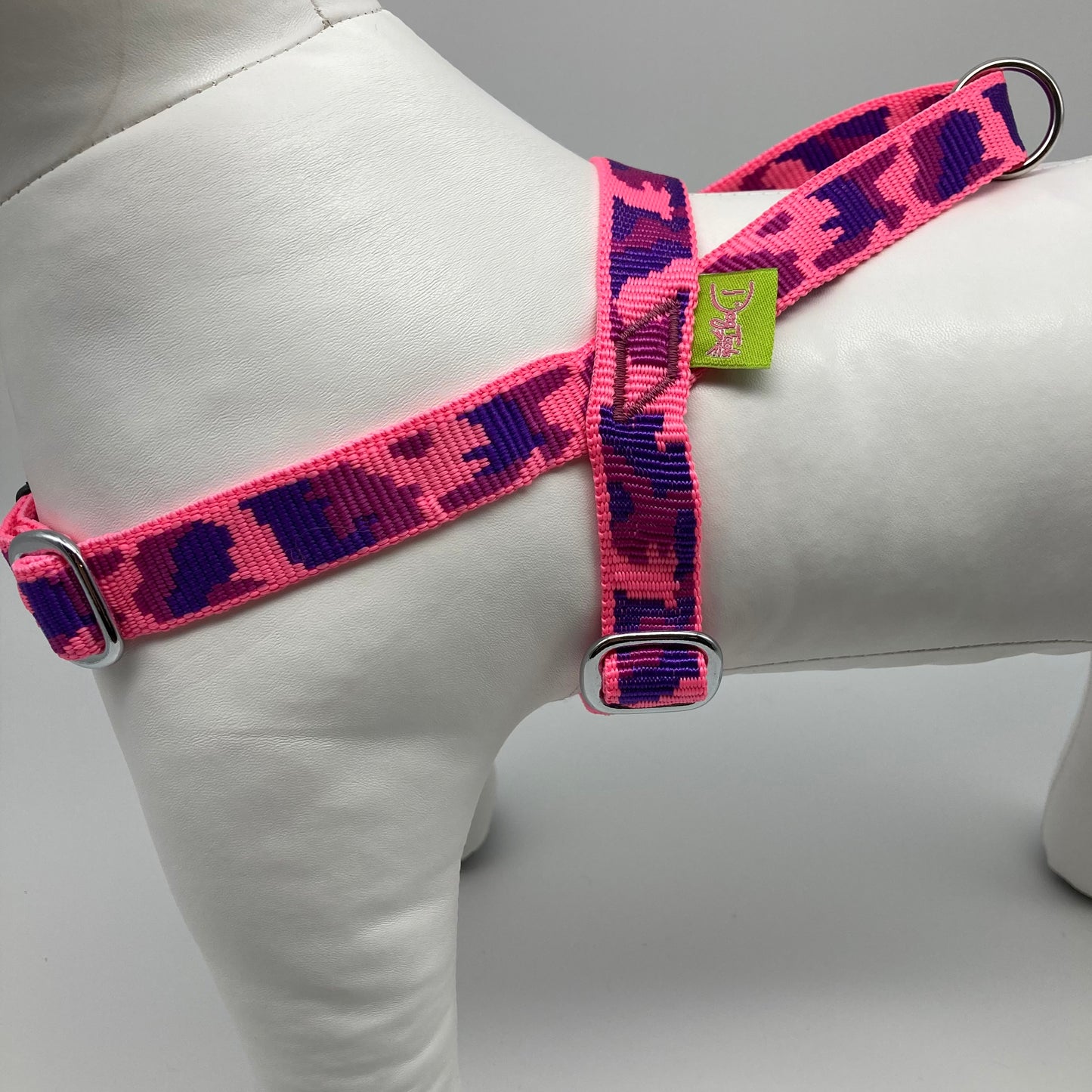 army pink (army print in 3 colors, fushia, purple and pink) harness, from the side, showing the loop, the stainless steel parts and the applegreen label
