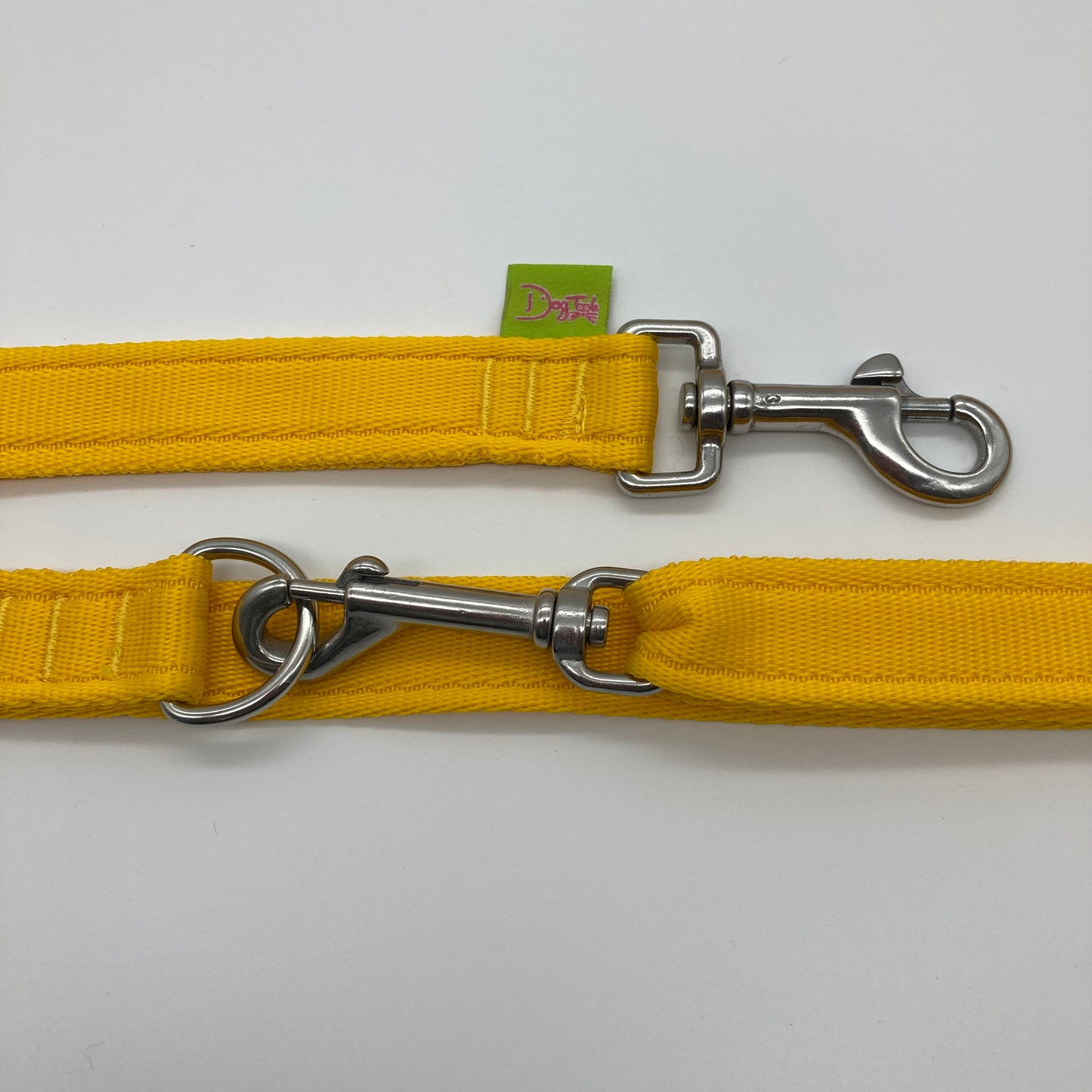 yellow multifunctional leash in size large, showing the 2 stainless steel hooks and the applegreen label with DogTools logo on it