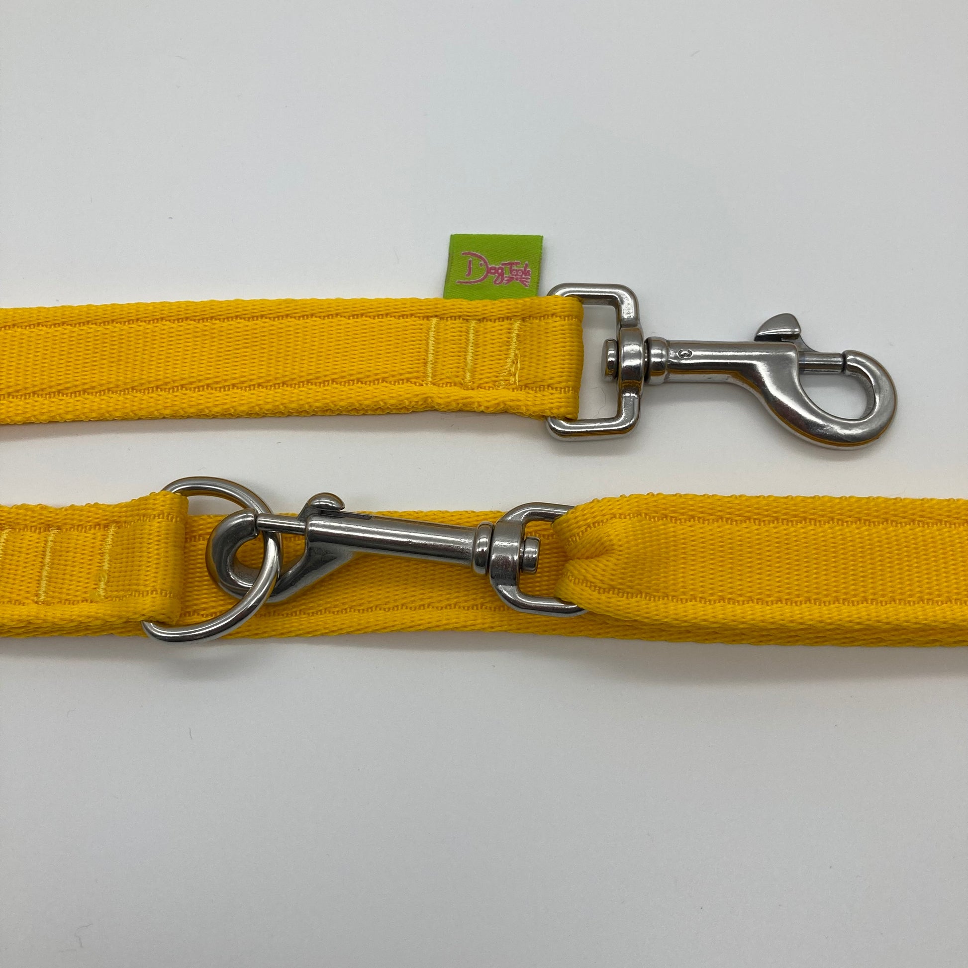 yellow multifunctional leash in size large, showing the 2 stainless steel hooks and the applegreen label with DogTools logo on it