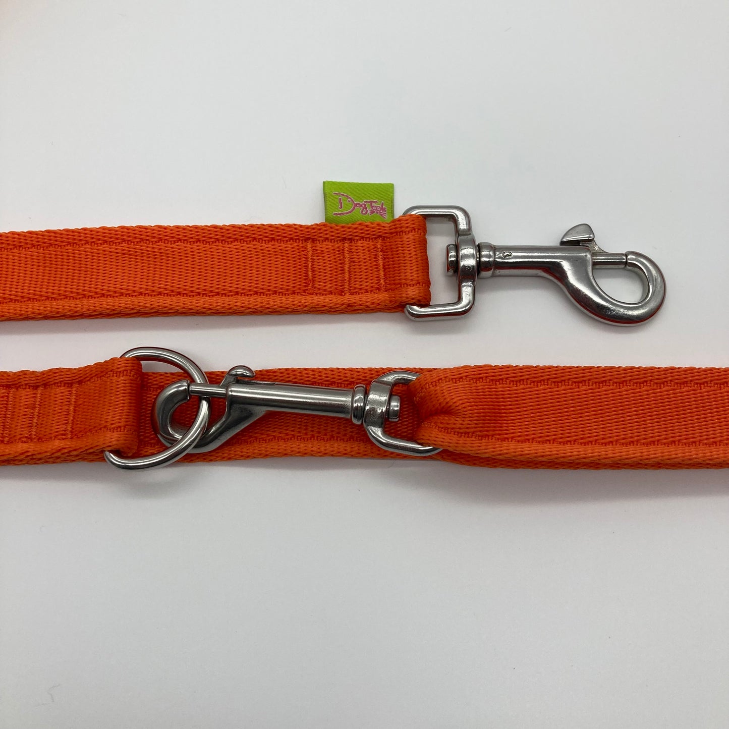 orange multifunctional leash in size large, showing the 2 stainless steel hooks and the applegreen label with DogTools logo on it