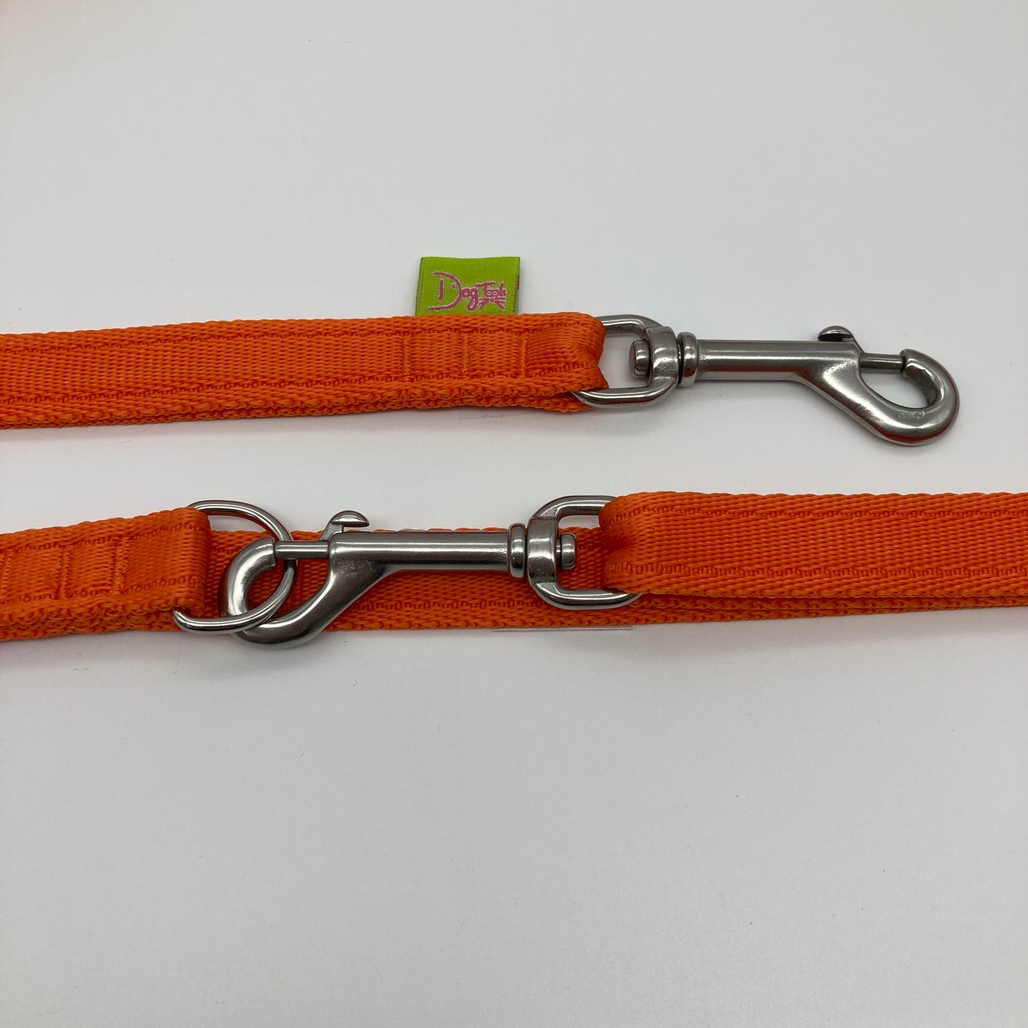 orange multifunctional leash in size small, showing the 2 stainless steel hooks and the applegreen label with DogTools logo on it