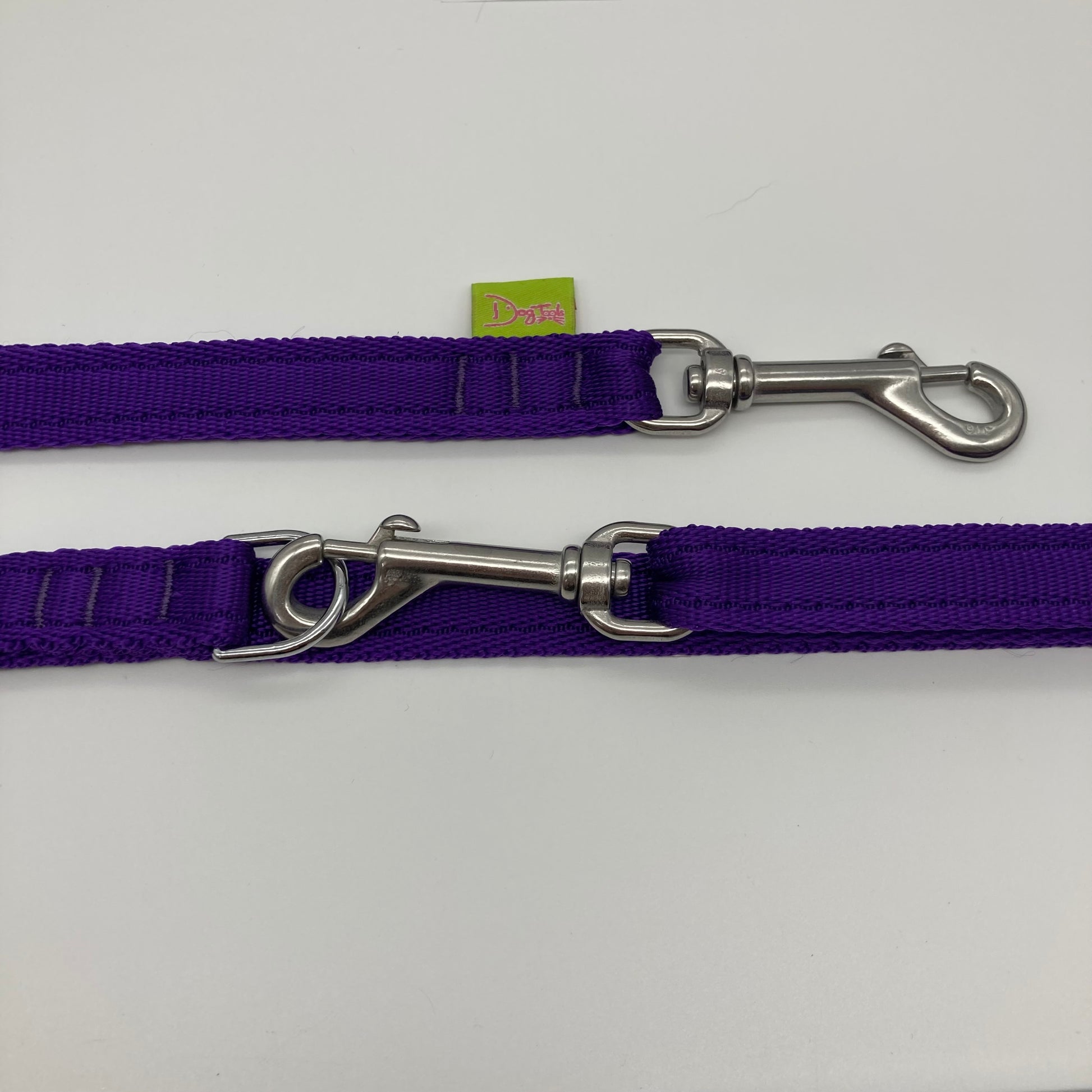 purple multifunctional leash in size small, showing the 2 stainless steel hooks and the applegreen label with DogTools logo on it