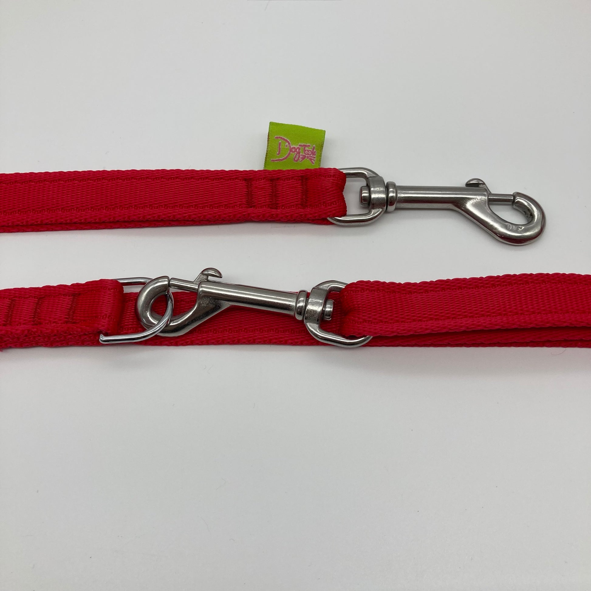 red multifunctional leash in size small, showing the 2 stainless steel hooks and the applegreen label with DogTools logo on it