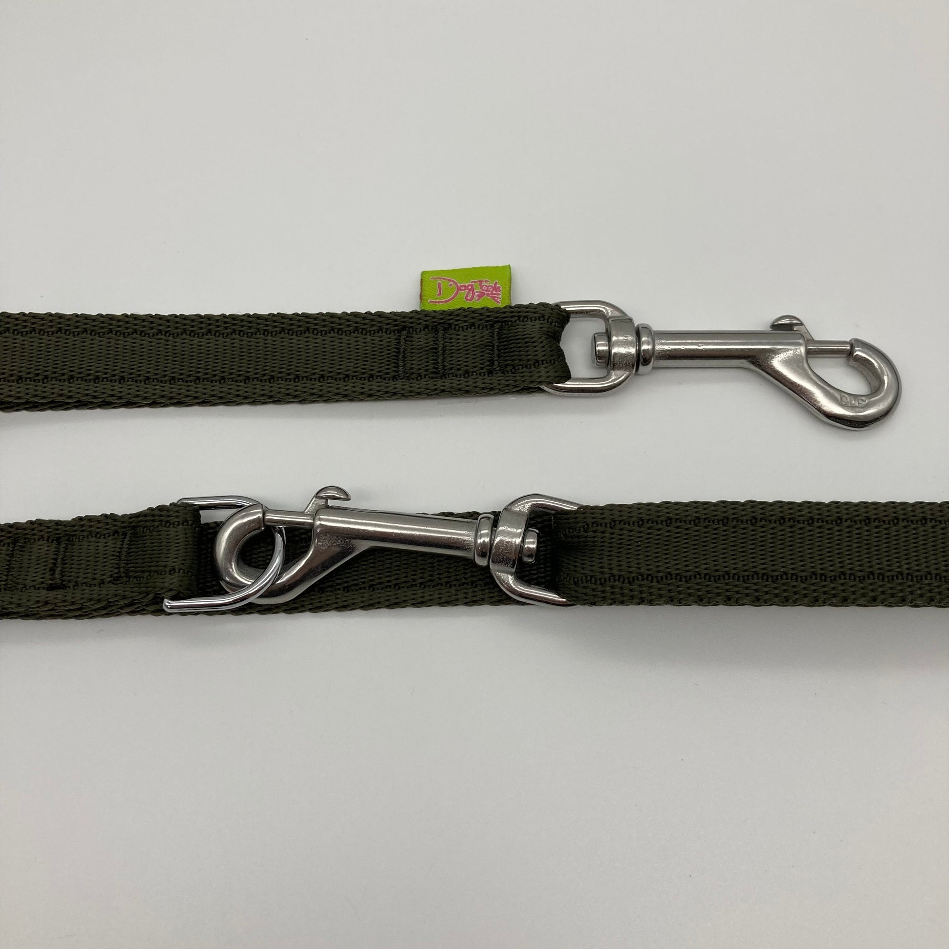 olive green multifunctional leash in size small, showing the 2 stainless steel hooks and the applegreen label with DogTools logo on it