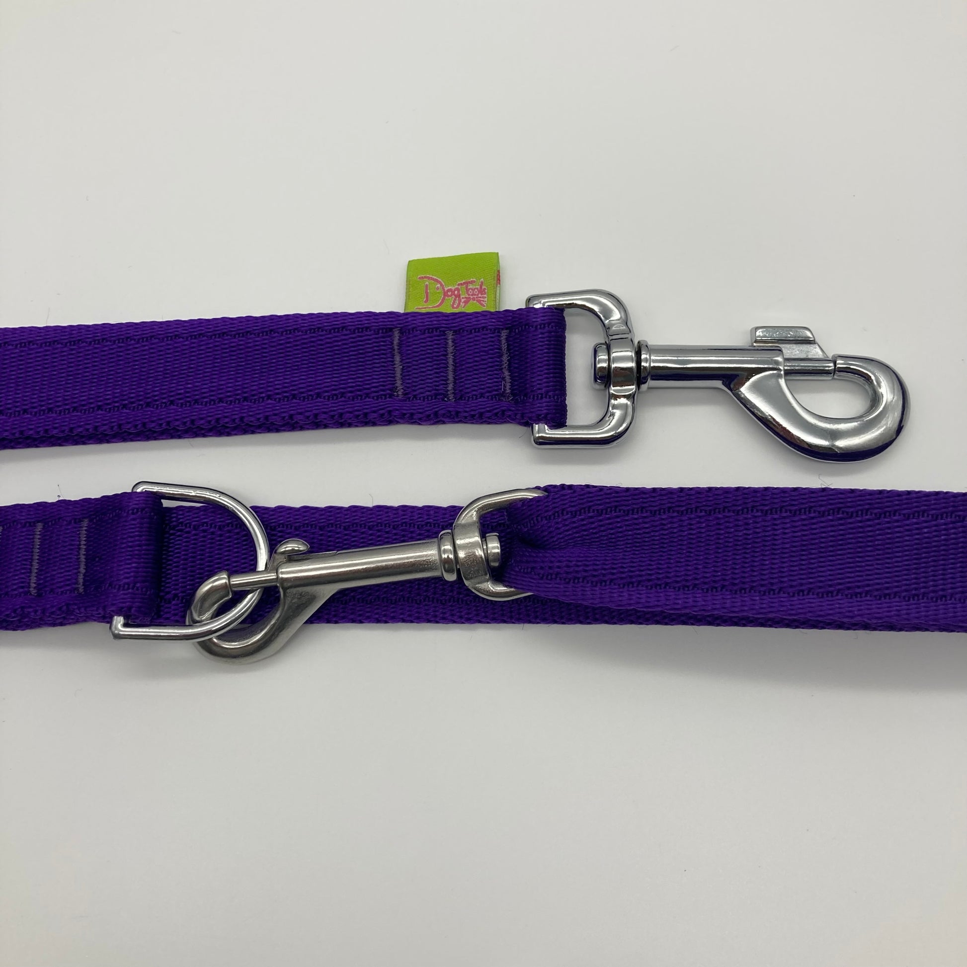 purple multifunctional leash in size large, showing the 2 stainless steel hooks and the applegreen label with DogTools logo on it