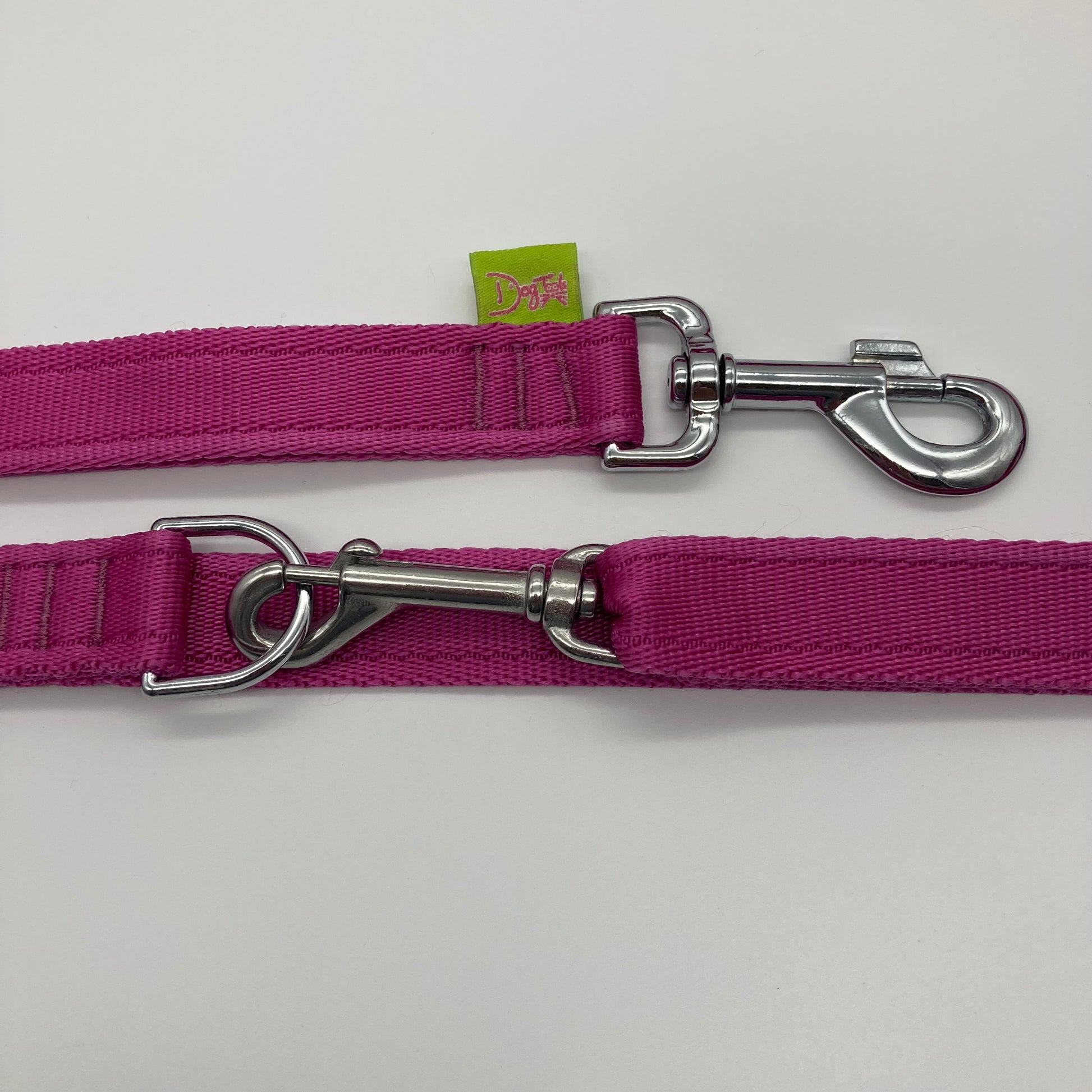 pink multifunctional leash in size large, showing the 2 stainless steel hooks and the applegreen label with DogTools logo on it