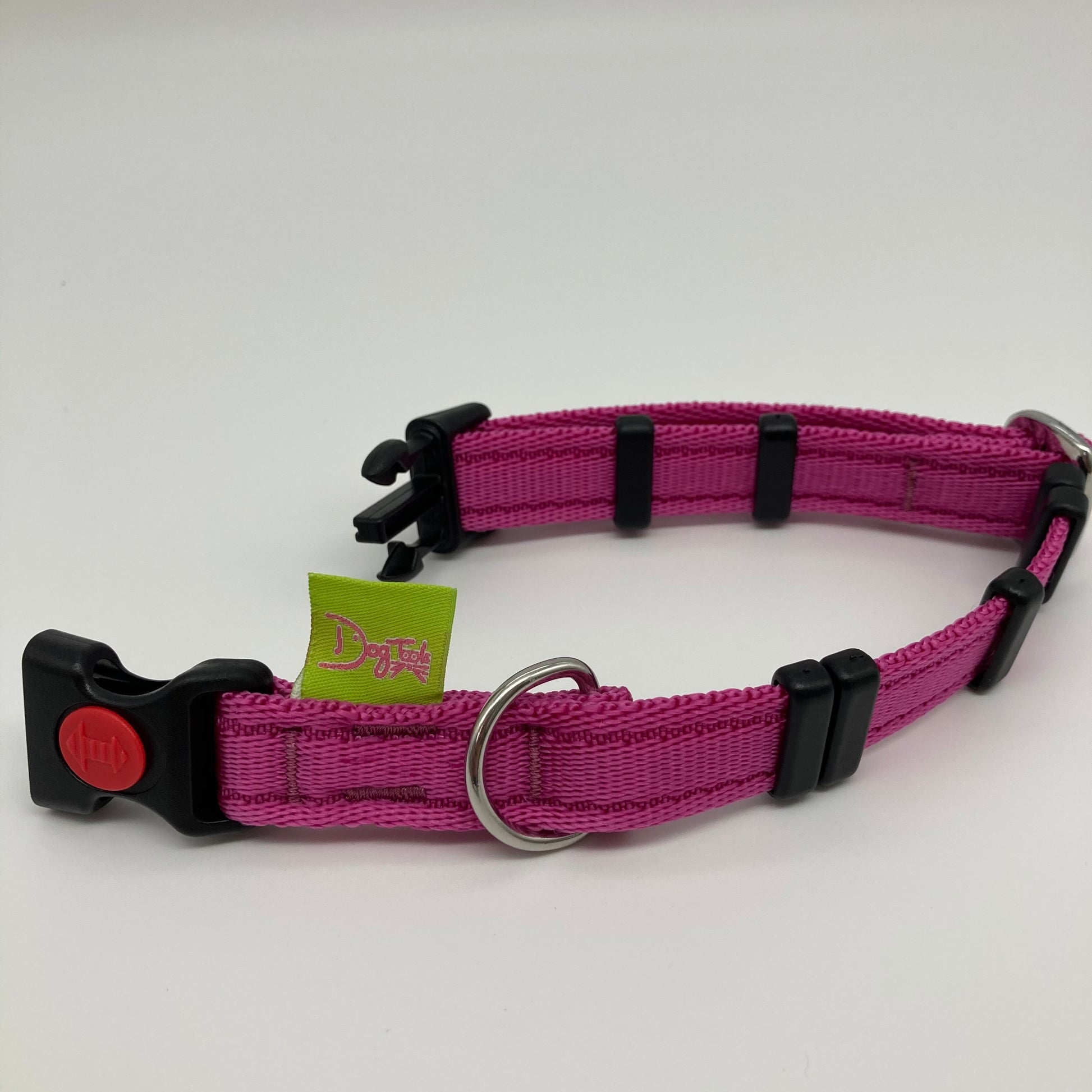 pink collar displayed on a white surface, unlocked, showing the black lock, stainless steel ring, the black loops and the applegreen DogTools label