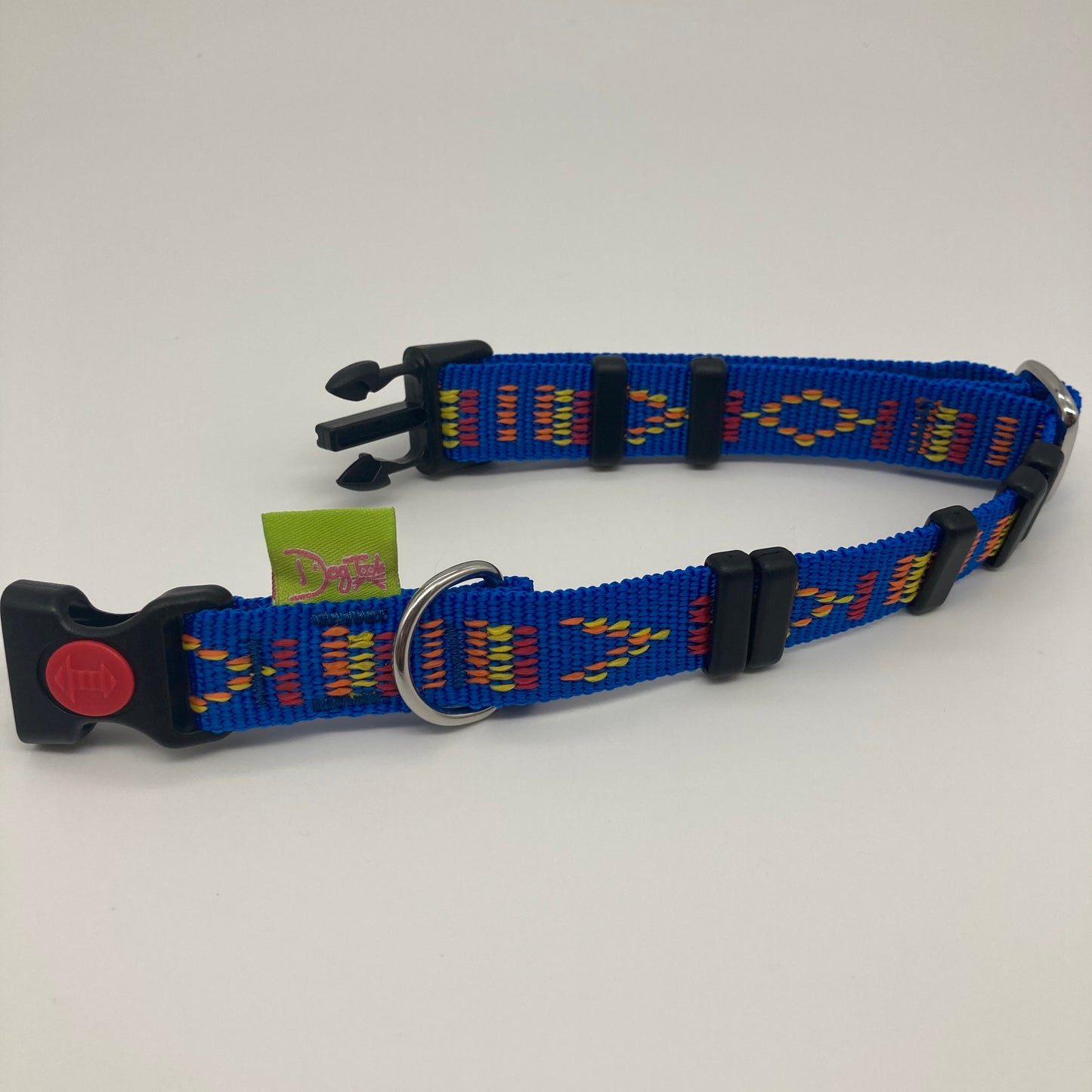 blue Stitch (blue fabric with print in 3 colors, red, yellow and orange) collar displayed on a white surface, unlocked, showing the black lock, stainless steel ring, the black loops and the applegreen DogTools label