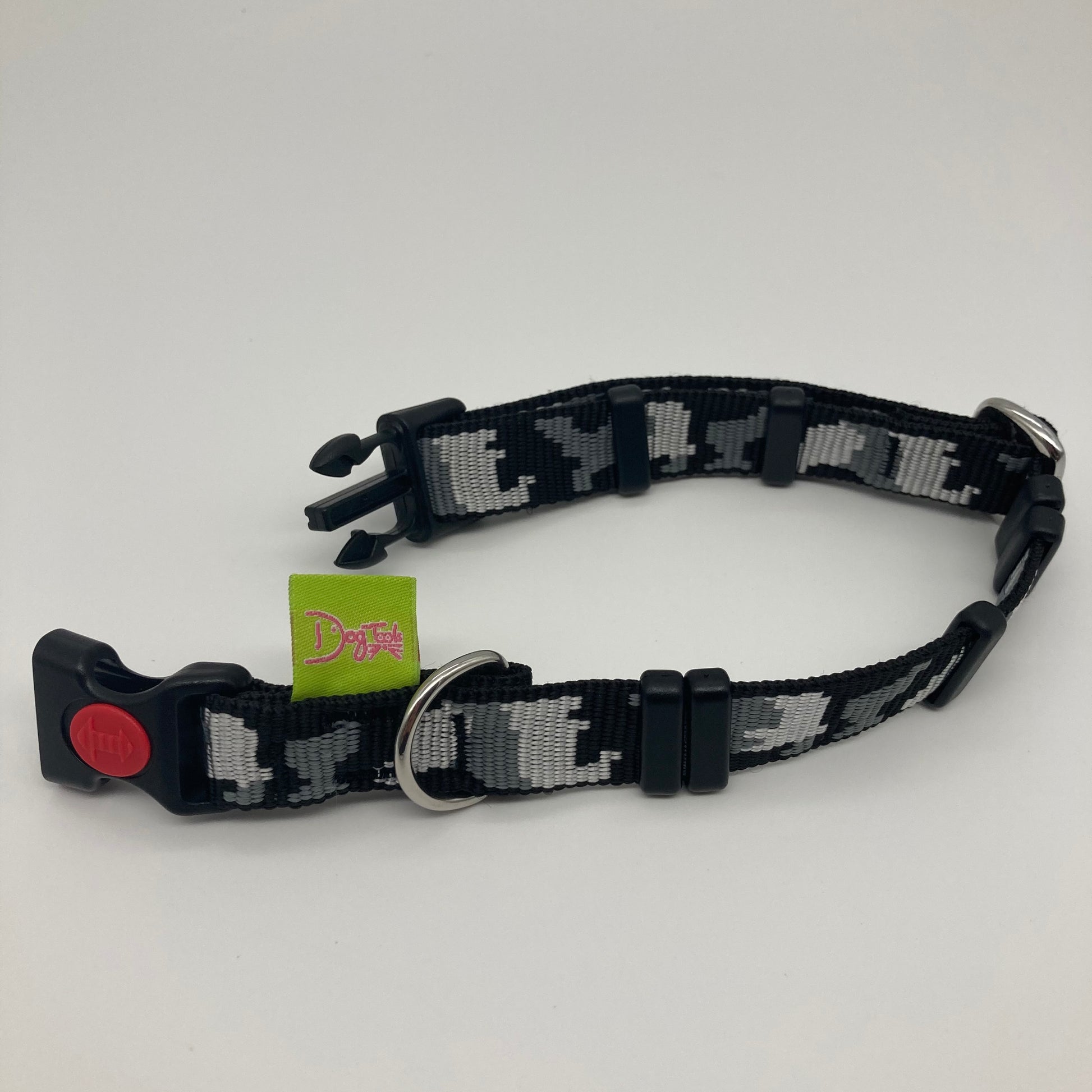 army grey (army print in 3 colors, dark grey, light grey and black) collar displayed on a white surface, unlocked, showing the black lock, stainless steel ring, the black loops and the applegreen DogTools label