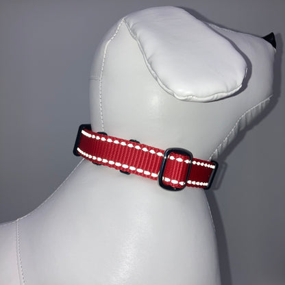red collar with light reflecting stitches displayed on a stuffed toy (dog), showing the back of the head and the collar from behind