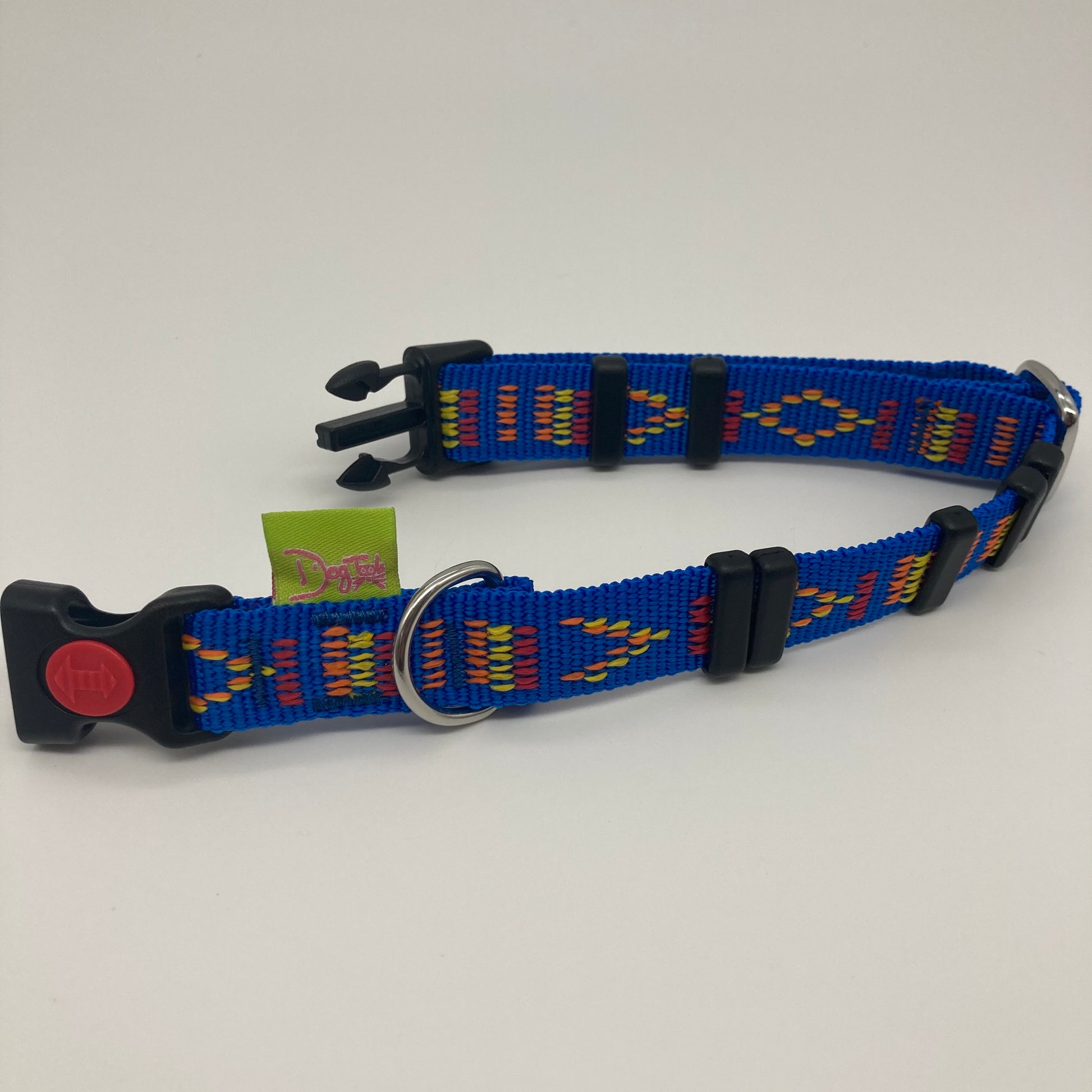 blue Stitch (blue fabric with print in 3 colors, red, yellow and orange) collar displayed on a white surface, unlocked, showing the black lock, stainless steel ring, the black loops and the applegreen DogTools label